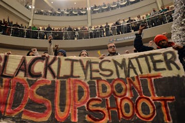 Demonstrators filled the Mall of America rotunda and chanted "Black lives matter" to protest police brutality, Saturday, Dec. 12, 2014, in Bloomington