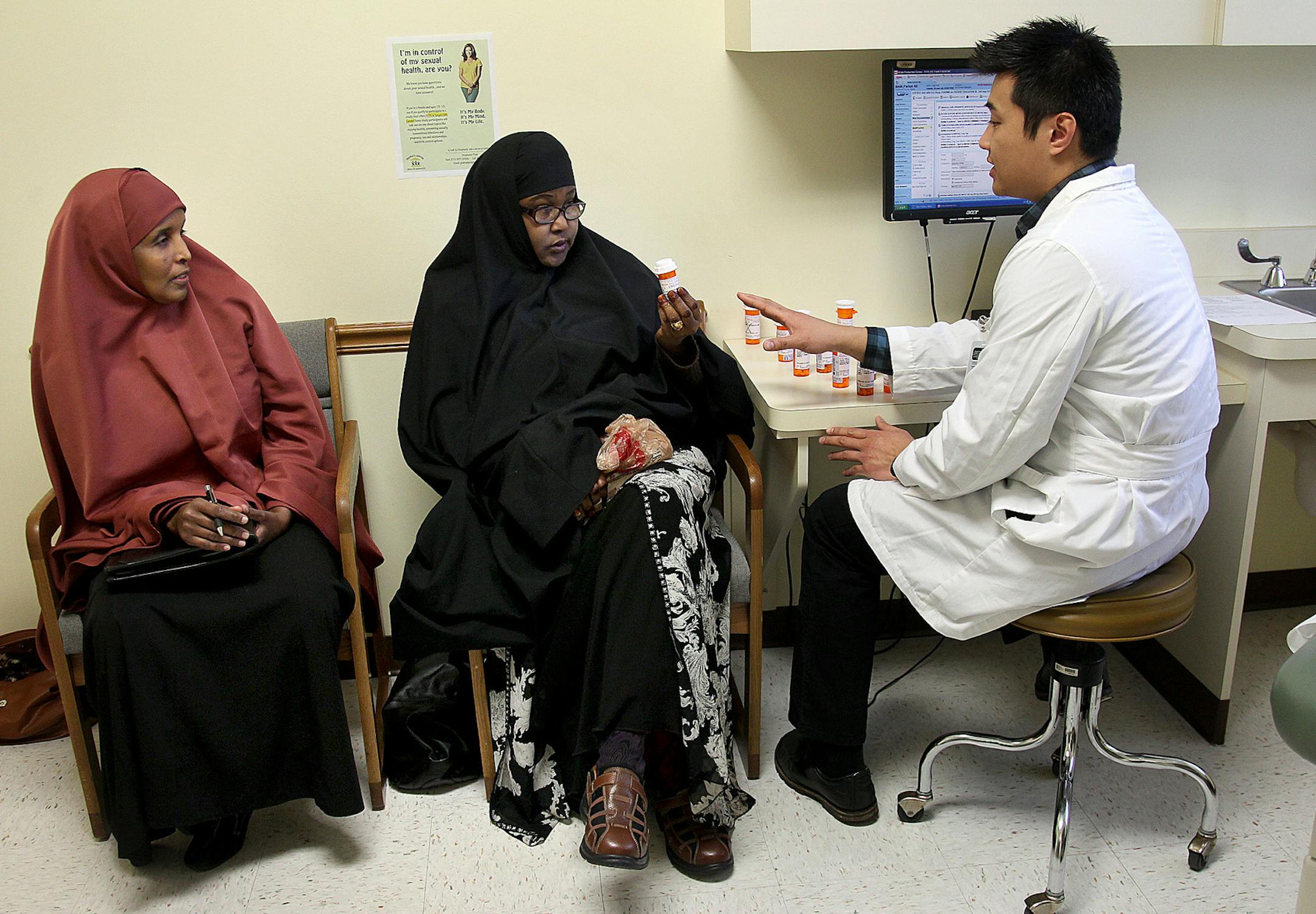 Sadia Noor, a Somali interpreter, left, helped patient Fartun Amiir, center, talk to PharmD Eric Hung at People's Center Clinic, Friday, March 29, 2013 in Minneapolis, MN. (ELIZABETH FLORES/STAR TRIBUNE) ELIZABETH FLORES &#x2022; eflores@startribune.com