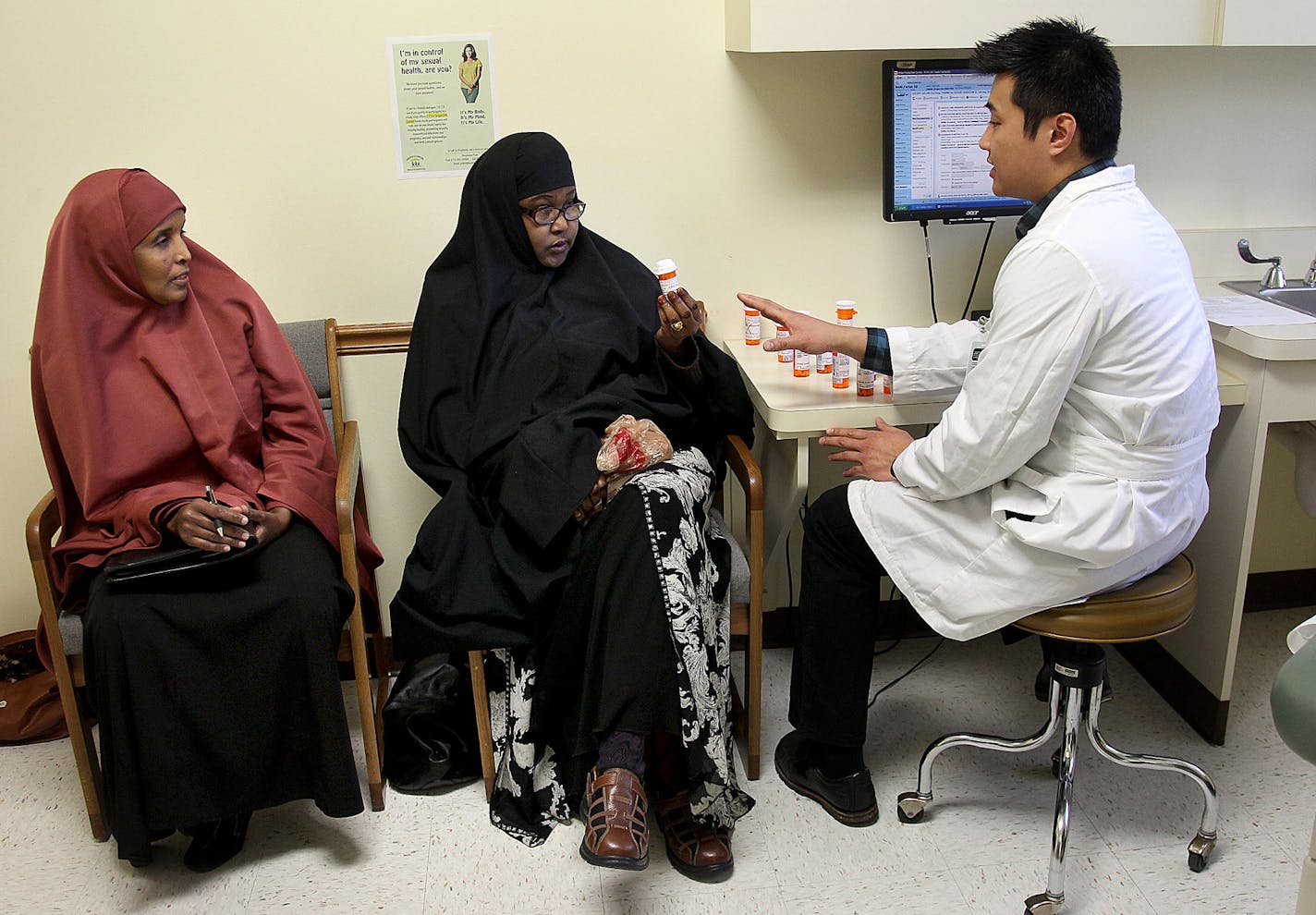 Sadia Noor, a Somali interpreter, left, helped patient Fartun Amiir, center, talk to PharmD Eric Hung at People's Center Clinic, Friday, March 29, 2013 in Minneapolis, MN. (ELIZABETH FLORES/STAR TRIBUNE) ELIZABETH FLORES &#x2022; eflores@startribune.com