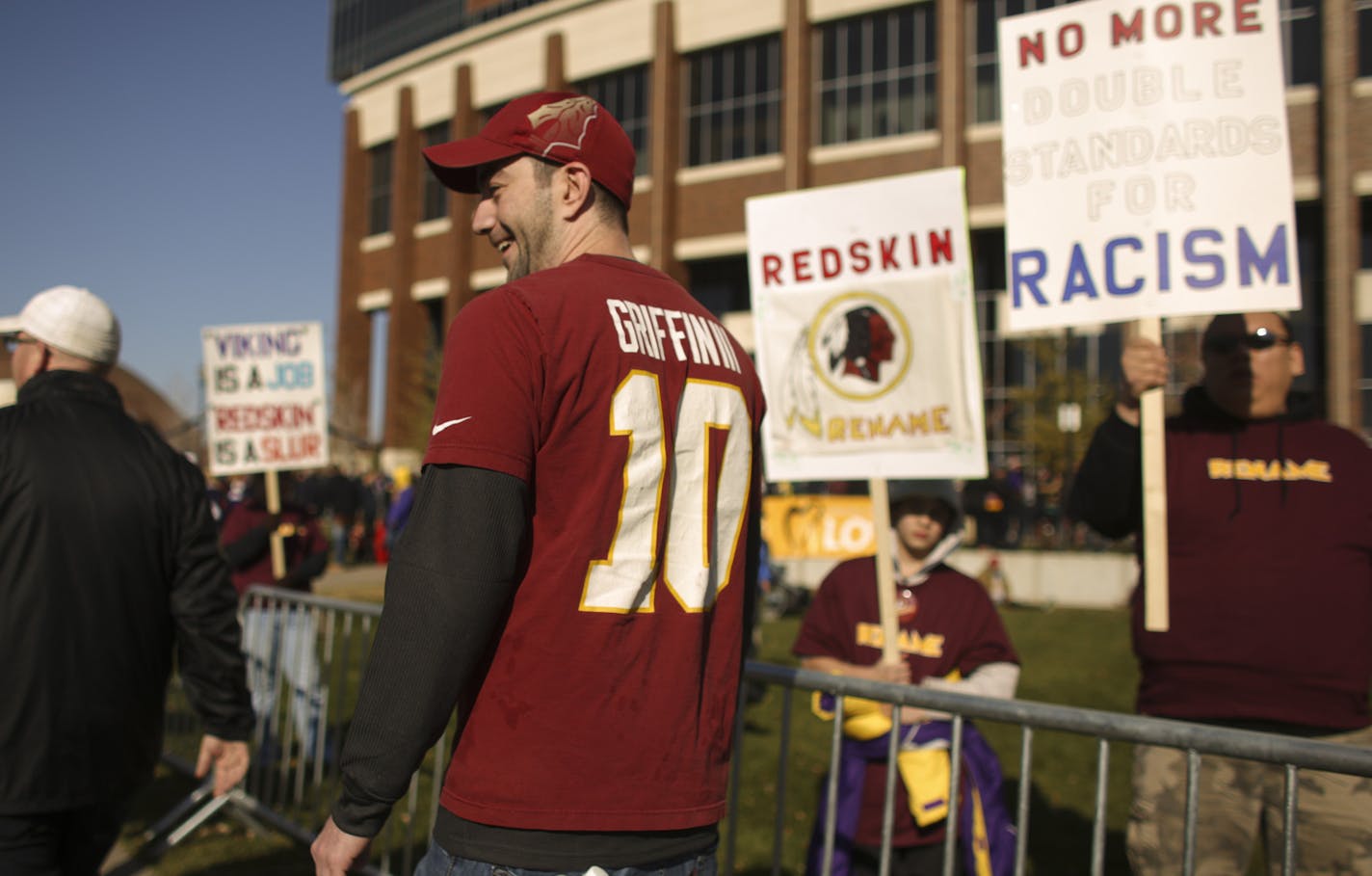 Manila Ikonowmidis of Minneapolis and a fan of the Washington team, walked past demonstrators opposed to the Washington team name and logo outside TCF Bank Stadium Sunday morning before the Vikings game. ] JEFF WHEELER &#x201a;&#xc4;&#xa2; jeff.wheeler@startribune.com A rally to protest the name of the Washington Redskins football club was held at TCF Bank Stadium before Sunday's Vikings game against the team from Washington on November 2, 2014.