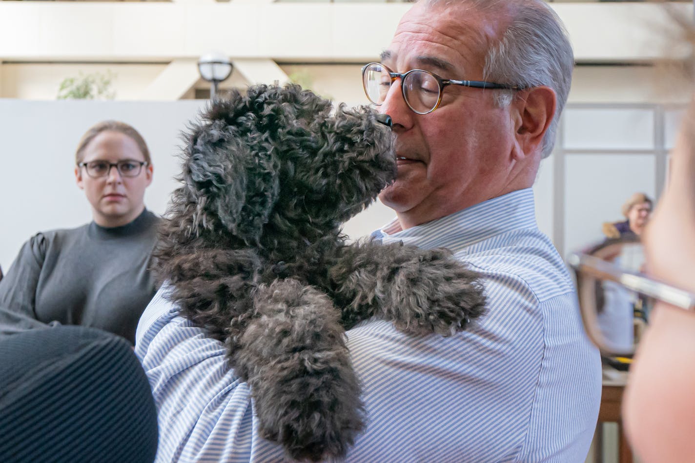 County Attorney Mike Freeman introduced the office's first ever emotional support animal, a golden doodle named Barrett. Barrett's trainer, Kathryn Neumann, right, was with them. The four month old puppy has lots of training ahead, then will be used to help people in traumatic situations work better with the attorney's office. ] GLEN STUBBE • glen.stubbe@startribune.com Tuesday, December 31, 2019