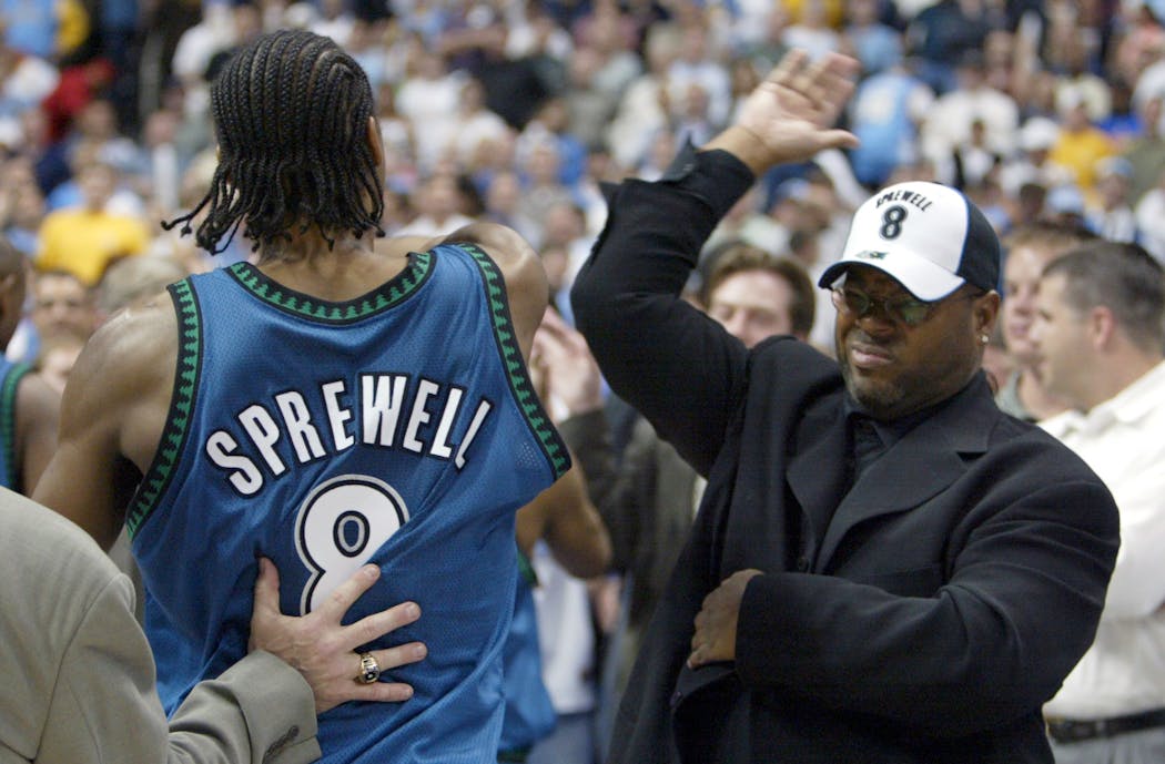 Minnesota's Latrell Sprewell high-fives Jimmy Jam as he walks of the court at the end of the playoff game. Minnesota beat Denver by a final score of 84-82.