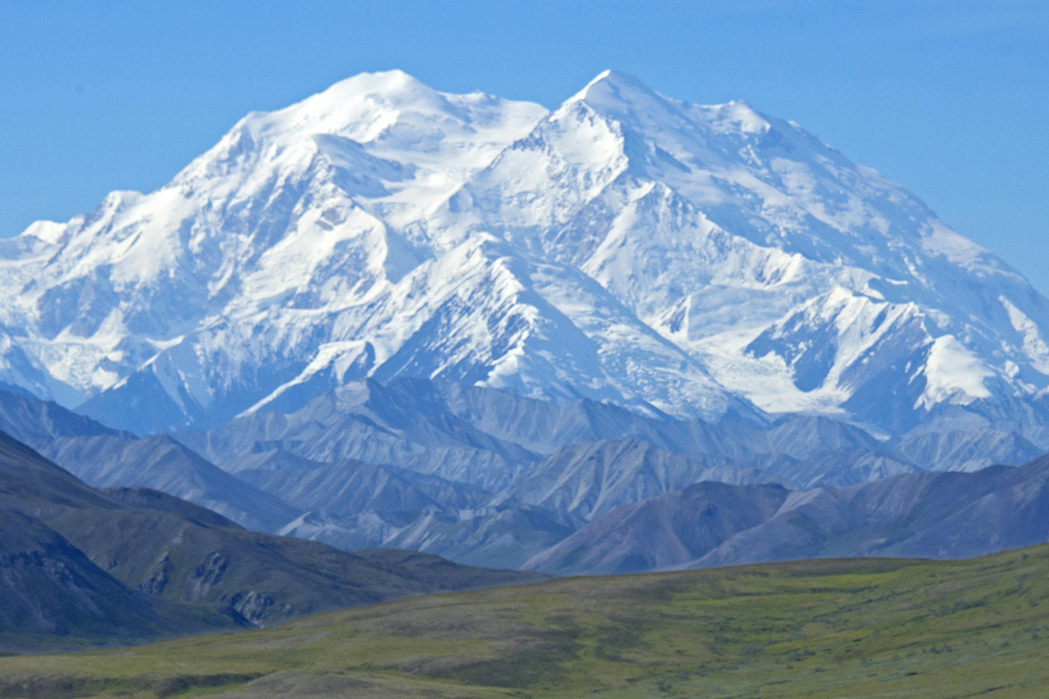 In this Monday, Aug. 3, 2015, photo provided by Holland America Line, a woman gazes at Mount McKinley in Denali National Park and Preserve in Alaska. On Sunday, Aug. 30, 2015, the White House said that President Barack Obama will change the name of North America's highest peak to Denali restoring an Alaska Native name with deep cultural significance. (Andy Newman/Holland America Line via AP) ORG XMIT: MIN2015090215032669