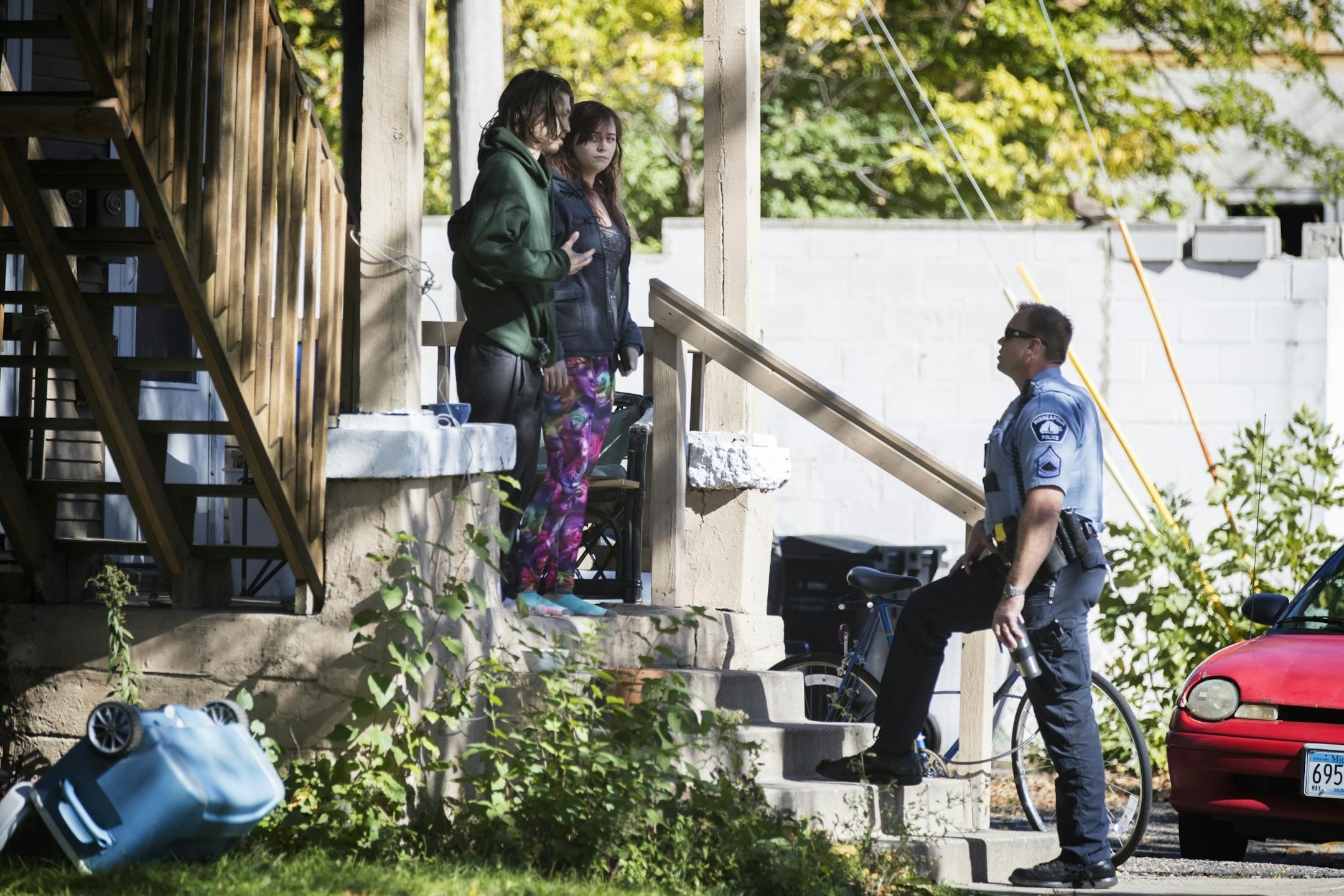 Potential witnesses are questioned by police near the scene of the shooting.