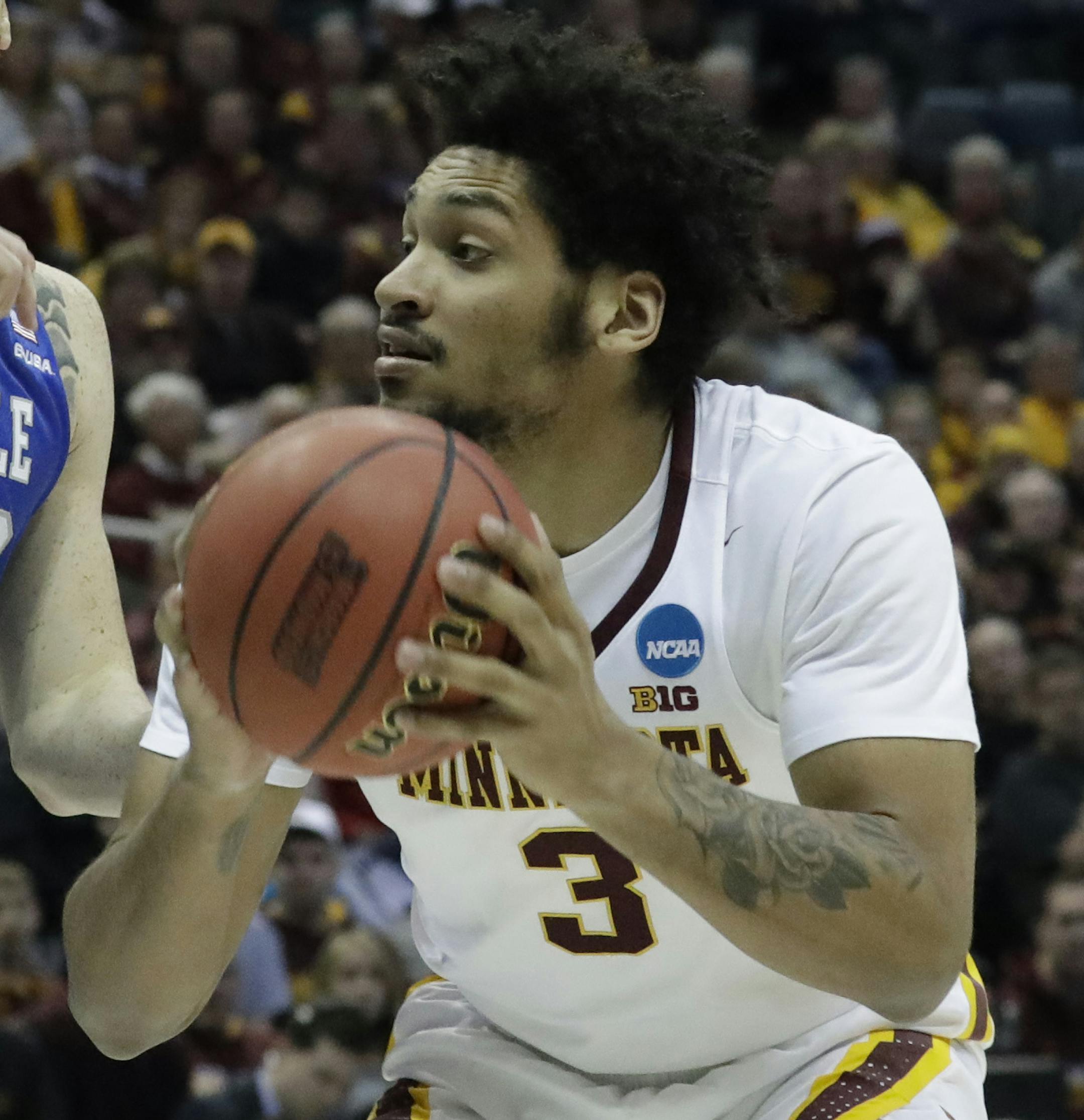 Minnesota's Jordan Murphy tries to drive past Middle Tennessee's Reggie Upshaw during the first half of an NCAA college basketball tournament first round game Thursday, March 16, 2017, in Milwaukee. (AP Photo/Morry Gash)