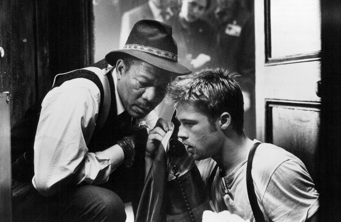 84-21A - Lt. William Somerset (Morgan Freeman, left) and Detective David Mills (Brad Pitt, right) receive a phone call from the elusive "John Doe" in New Line Cinema's mystery-thriller, Seven. Peter Sorel, New Line Cinema