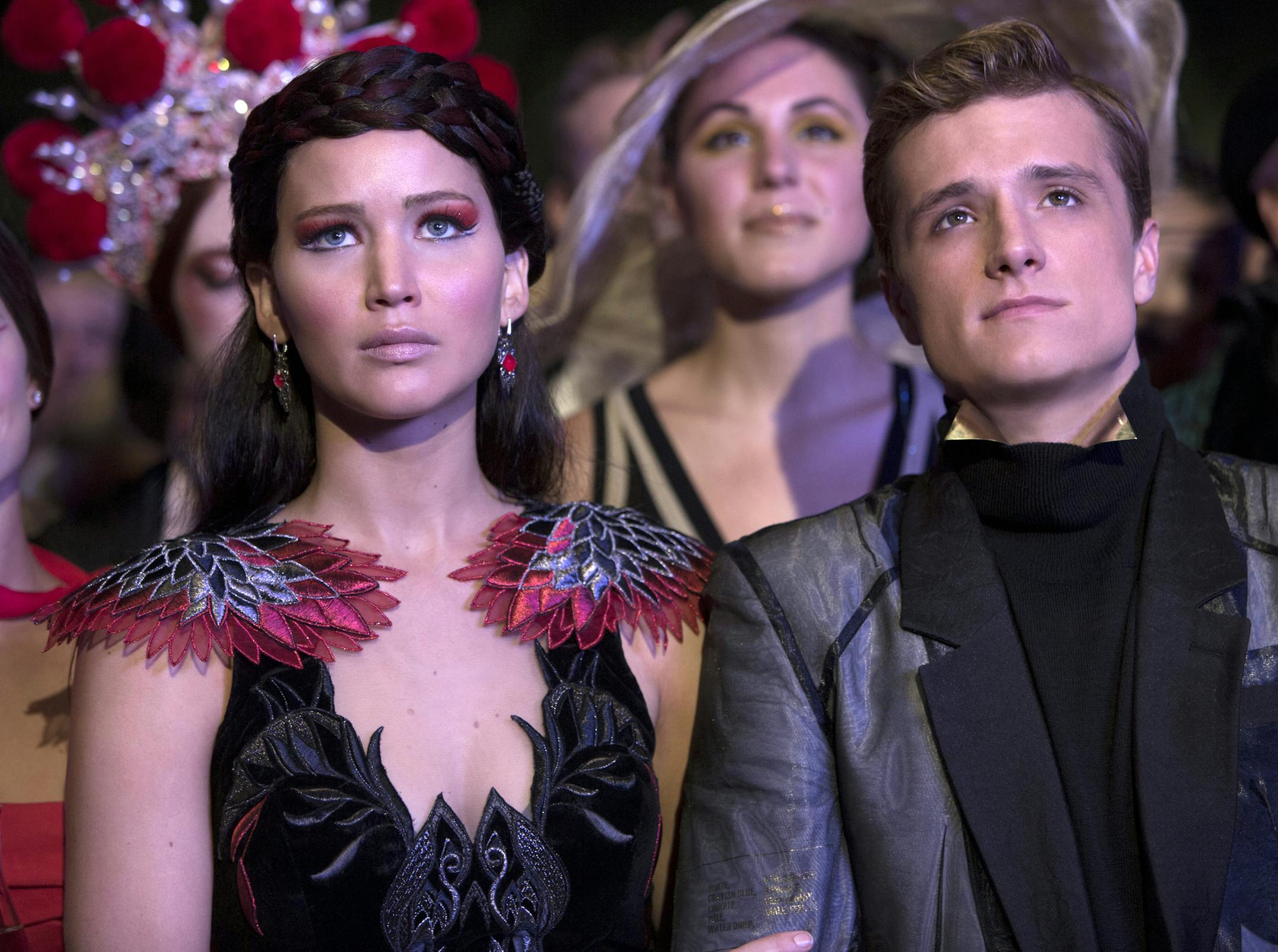This image released by Lionsgate shows Jennifer Lawrence as Katniss Everdeen, left, and Josh Hutcherson as Peeta Mellark in a scene from "The Hunger Games: Catching Fire." The film releases Nov. 22, 2013. (AP Photo/Lionsgate, Murray Close)