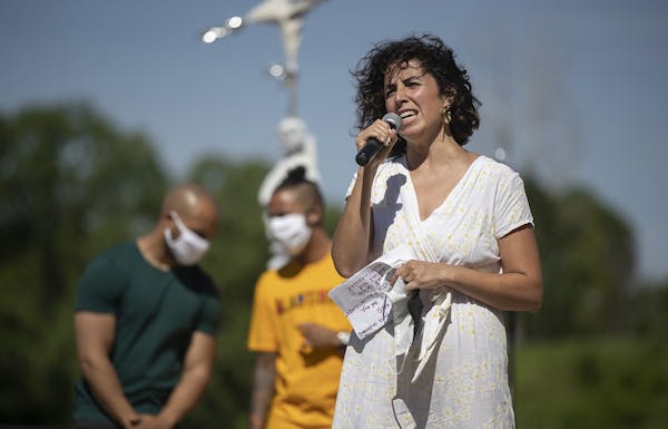 Alondra Cano, City Council 9th ward member, speaks to community members at "The Path Forward" meeting at Powderhorn Park, a meeting between the Minnea