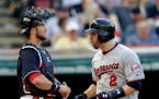 The Twins' Brian Dozier, right, celebrated in front of Cleveland catcher Yan Gomes after hitting the go-ahead home run in the eighth inning Saturday.