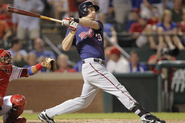 The Minnesota Twins' Justin Morneau follows through on his solo home run in the seventh inning against the Texas Rangers at Rangers Ballpark in Arling