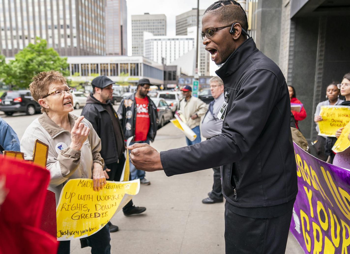 A security guard from Madison Equities, center, argues with protesters and urges them to clear the entrance of the building after they marched through the skyways. ] LEILA NAVIDI &#xa5; leila.navidi@startribune.com BACKGROUND INFORMATION: St. Paul workers who've filed complaints with the city about Earned Sick and Safe Time violations at their workplaces and organizers demonstrate at St. Paul City Hall and in the skyways on Wednesday, May 22, 2019. St. Paul's Earned Sick and Safe Time law went i