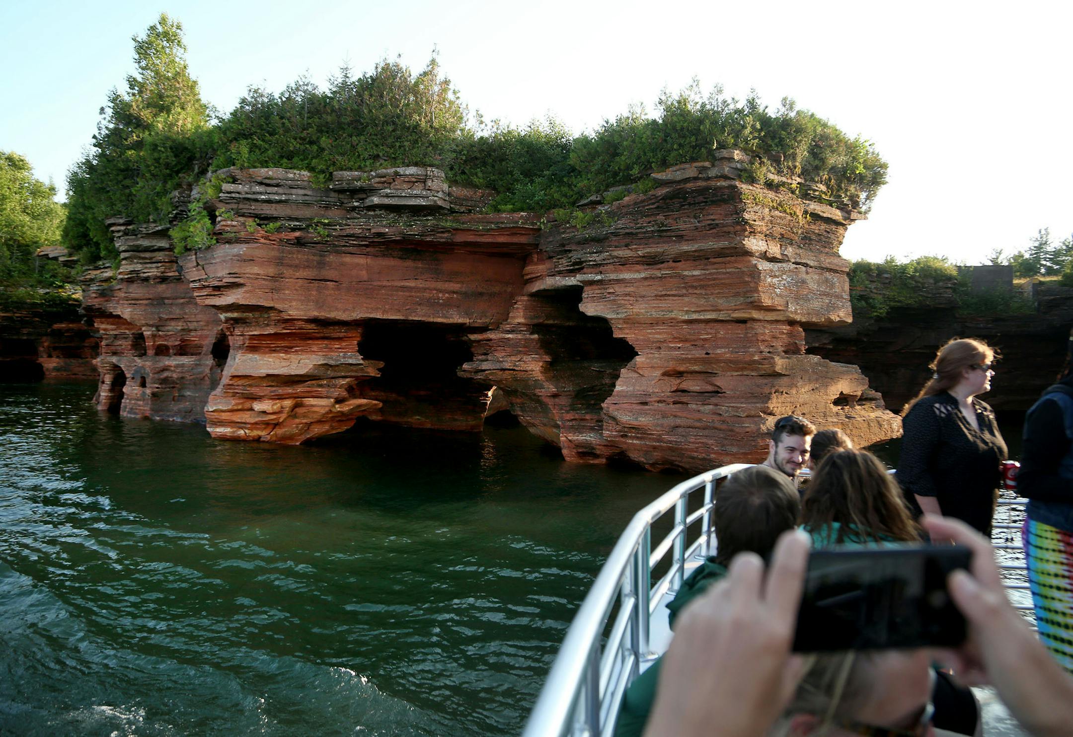 The Evening Grand Tour of Apostle Islands Cruises passes the stunning sea caves of Devils Islands two times, giving passengers time to enjoy and photograph the wonder. By David Joles