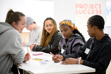 From left, Project Success Facilitator Clara Kennedy works with Minneapolis high school seniors Maya Ndjarakana, Riyah Wooley and Adrien Brown during 