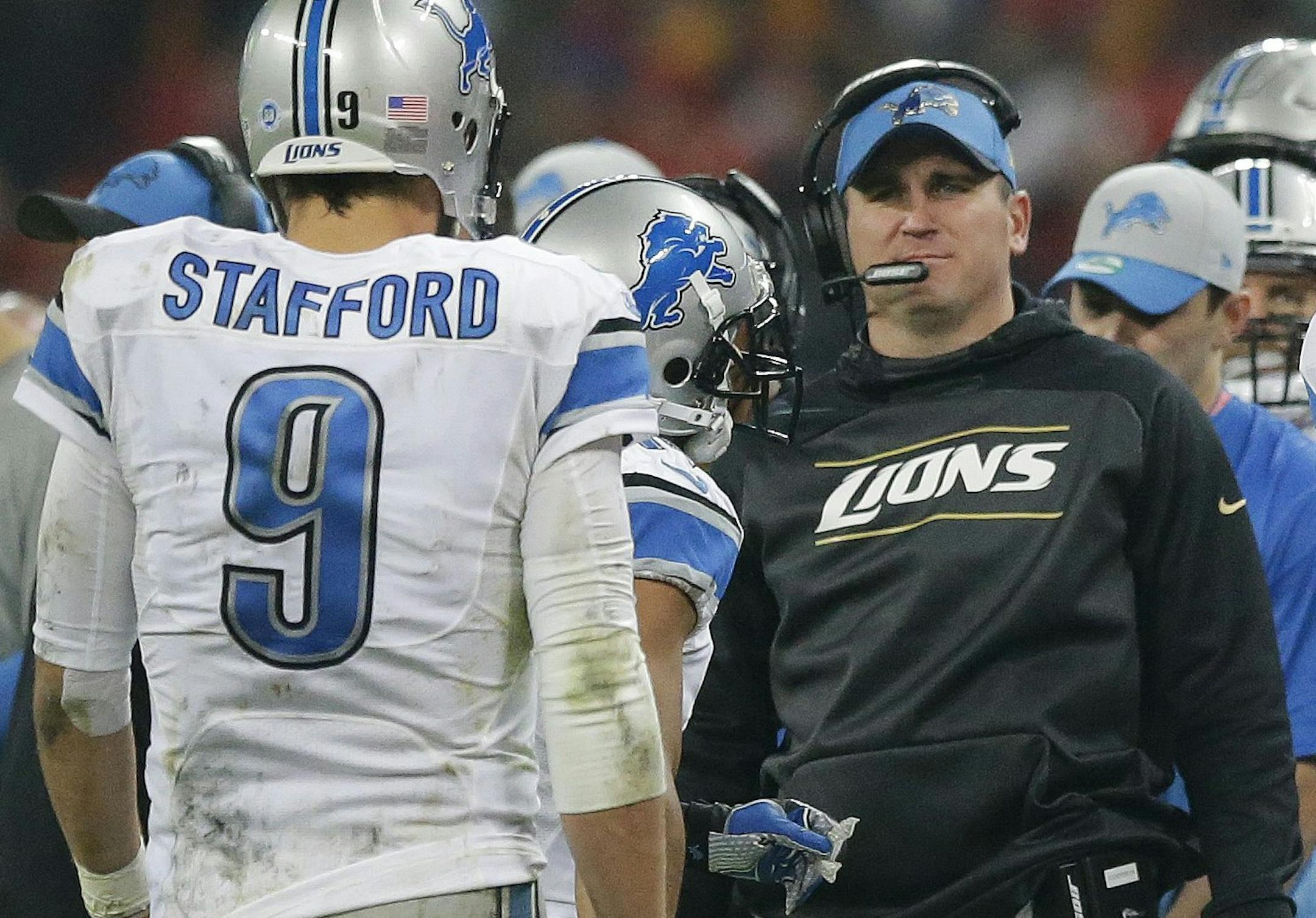 Detroit Lions quarterback Matthew Stafford (9), left, walks towards wide receiver Calvin Johnson (81) and Detroit Lions offensive co-ordinator Jim Bob Cooter on the touchline during the NFL football game between Detroit Lions and Kansas City Chiefs Wembley Stadium in London, Sunday, Nov. 1, 2015. (AP Photo/Matt Dunham) ORG XMIT: TH181