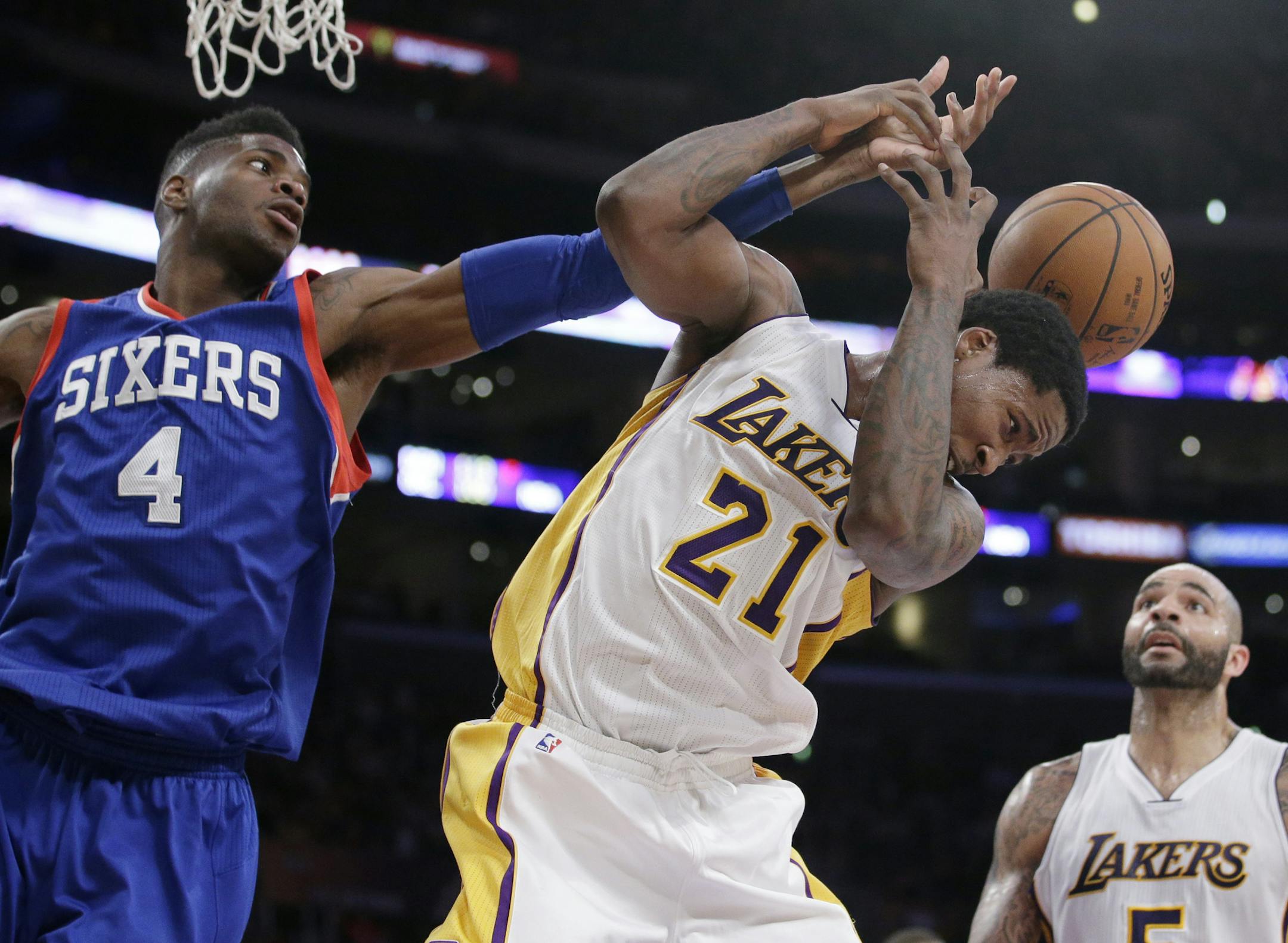Los Angeles Lakers' Ed Davis, right, and Philadelphia 76ers' Nerlens Noel fight for a rebound during the second half of an NBA basketball game, Sunday, March 22, 2015, in Los Angeles. The Lakers 101-87. (AP Photo/Jae C. Hong)