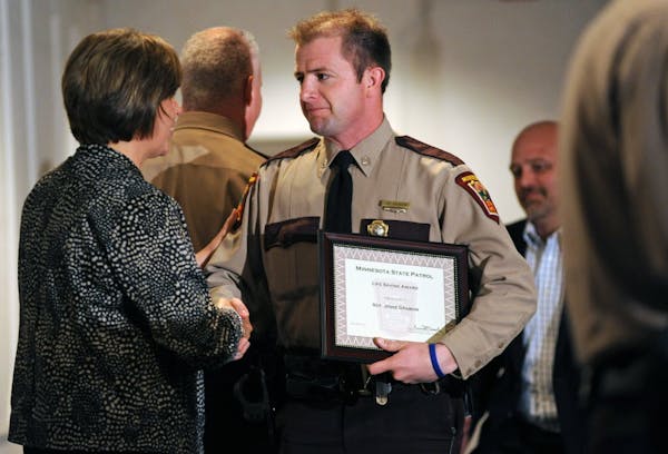 Minnesota Department of Public Safety Commissioner Mona Dohman congratulated State Patrol Sgt. Jesse Grabow, who was among those honored on Monday.