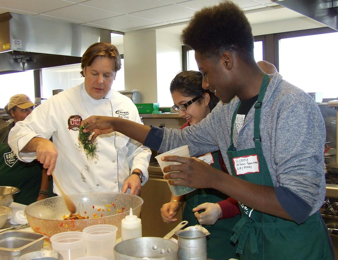 Chef Matt Quist of Taher helped Jasmine Herrarty and Victory George of Urban Ventures.