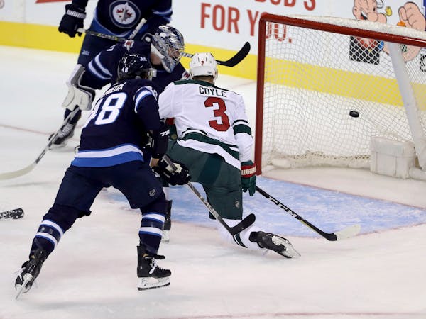 Wild forward Charlie Coyle (3) scored on Jets goaltender Connor Hellebuyck as forward Brendan Lemieux (48) looked on in front of the net during the fi