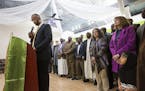 Jaylani Hussein, the executive director CAIR-MN pauses while speaking during a press conference at Abubakar Islamic Center as Iasha Osman, far right, 