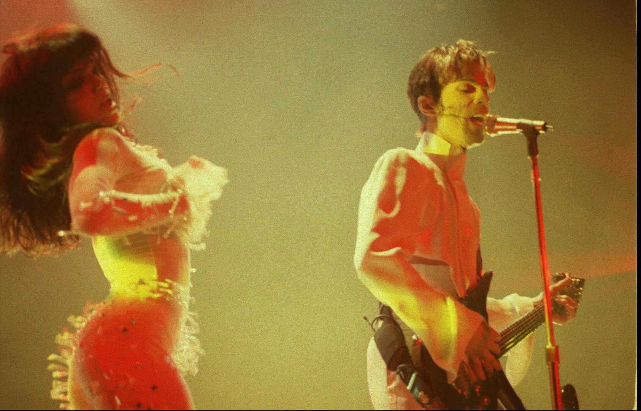 The artist formerly known as Prince performs in Honolulu, Hawaii, on Feb. 16, 1996, with his new bride, Mayte.