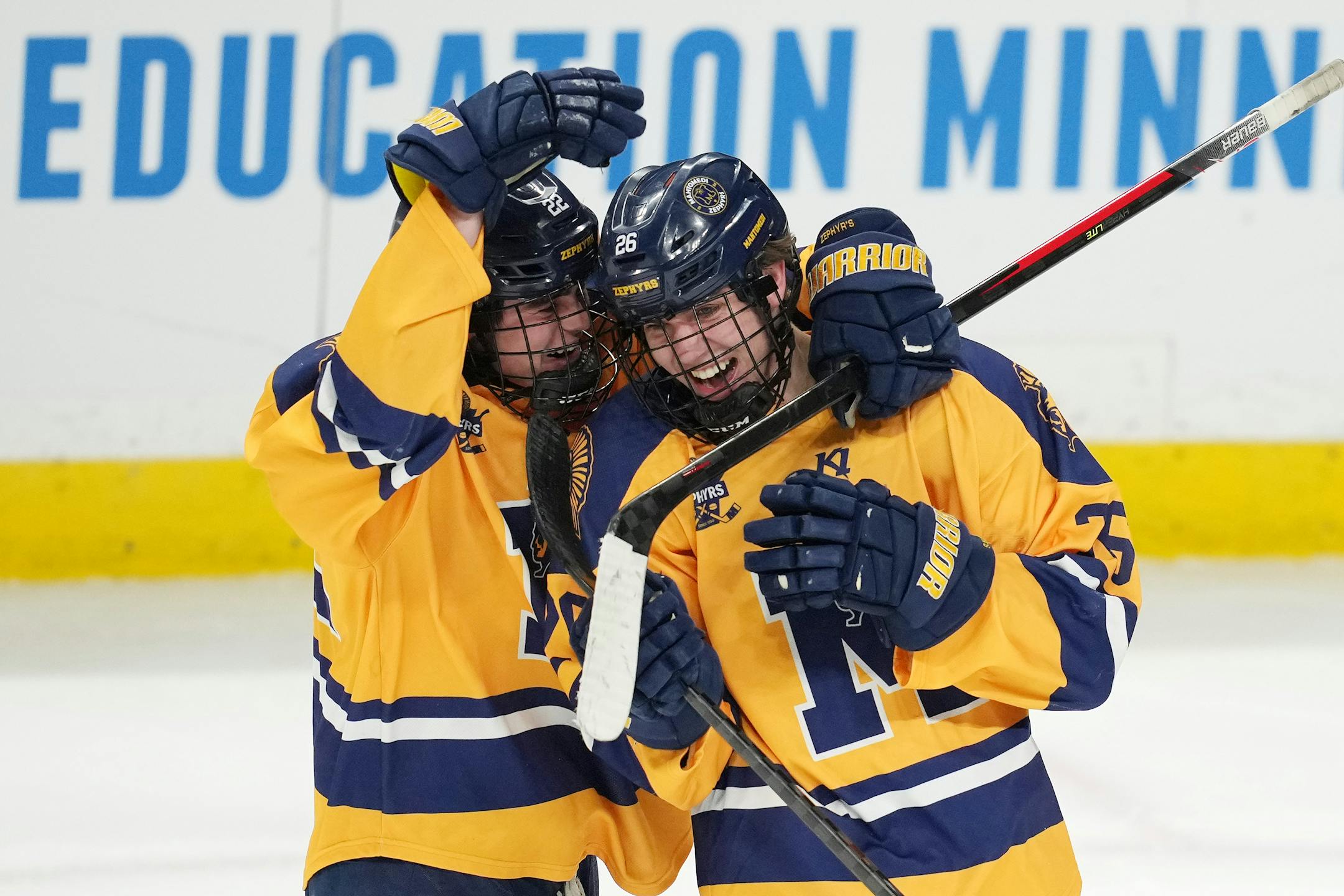 Mahtomedi defenseman Carson Marshall (26) is congratulated by forward Carter Haycraft (22) after scoring in the third period of a MSHSL Class 1A quarterfinal hockey game between Alexandria and Mahtomedi.