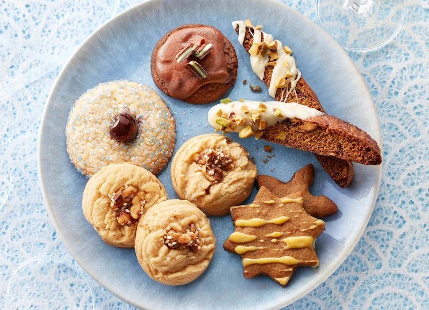 The winning cookies for the 2022 Star tribune Holiday Cookie Contest: Maple-Roasted Walnut Delights, Cherry Cardamom Buttons, Grasshoppers, Gingerbreaf Cornmeal Biscotti and Spiced Orange and Rye Shortbread Cookies. Photo by Dennis Becker and food styling by Lisa Golden Schroeder.