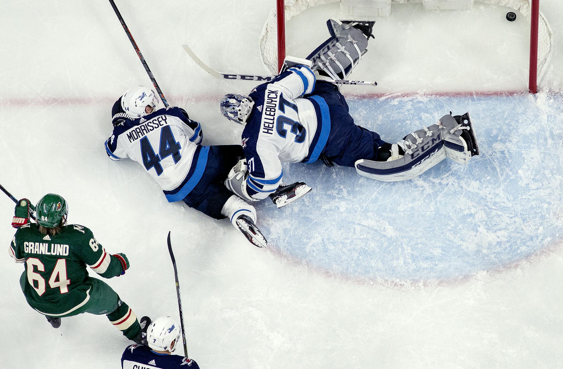 Mikael Granlund (64) got the puck past Connor Hellebuyck (37) for a goal in the first period. ] CARLOS GONZALEZ &#xef; cgonzalez@startribune.com &#xf1; April 15, 2018, St. Paul, MN, Xcel Energy Center, NHL, Stanley Cup Playoffs &#xf1; Game 3, Minnesota Wild vs. Winnipeg Jets