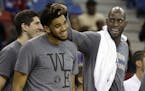 FILE - In this Nov. 27, 2015, file photo, Minnesota Timberwolves forward Kevin Garnett, right, rubs the head of teammate Karl-Anthony Towns as they ce