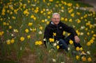 Warren Kapsner with a small portion of the daffodils he planted in his yard last year. ] JEFF WHEELER • jeff.wheeler@startribune.com