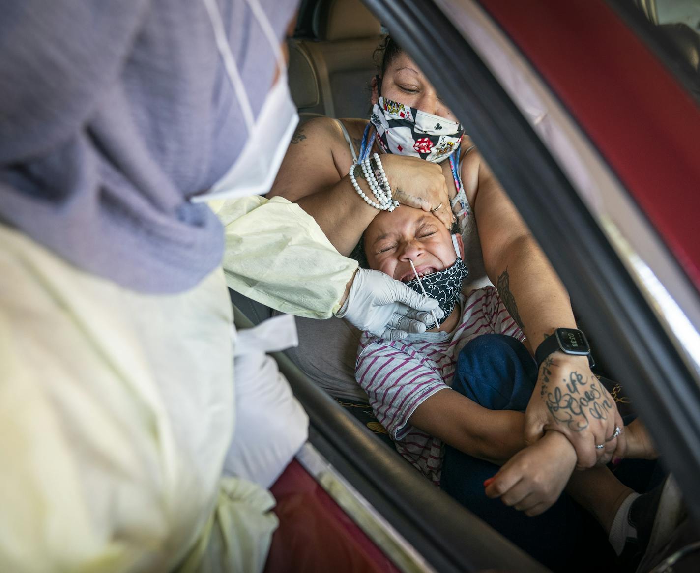 Jessica Steele of St. Paul held her son Little Bear Chatman, Jr., 6, as he was tested at North Memorial Health in Robbinsdale. The facility tested a total of 744 people on Friday, Nov. 6.