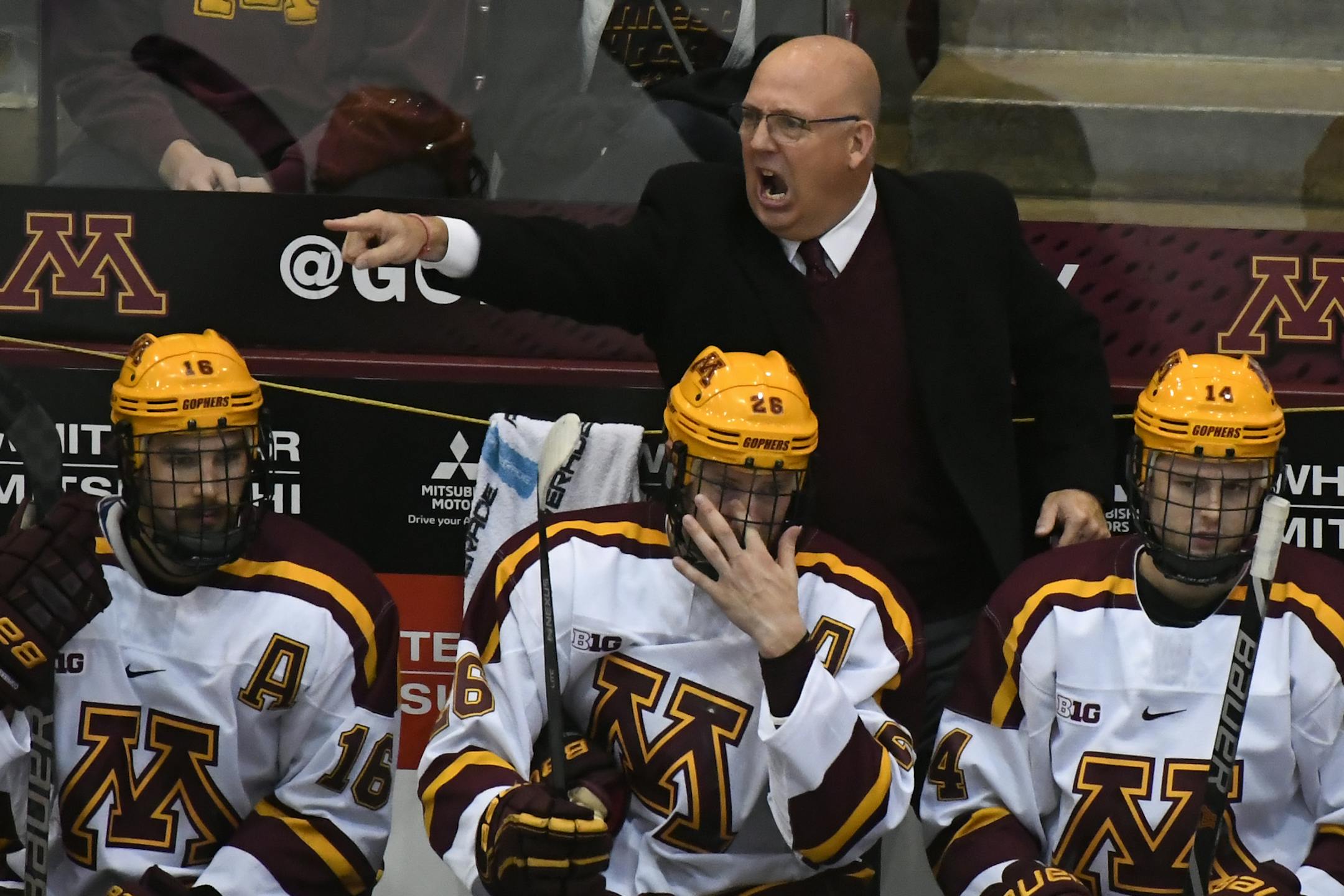 Minnesota head coach Bob Motzko directs his team during the third period of an NCAA college hockey game against Minnesota-Duluth in Minneapolis on Sunday, Oct. 7, 2018. (Aaron Lavinsky/Star Tribune via AP)