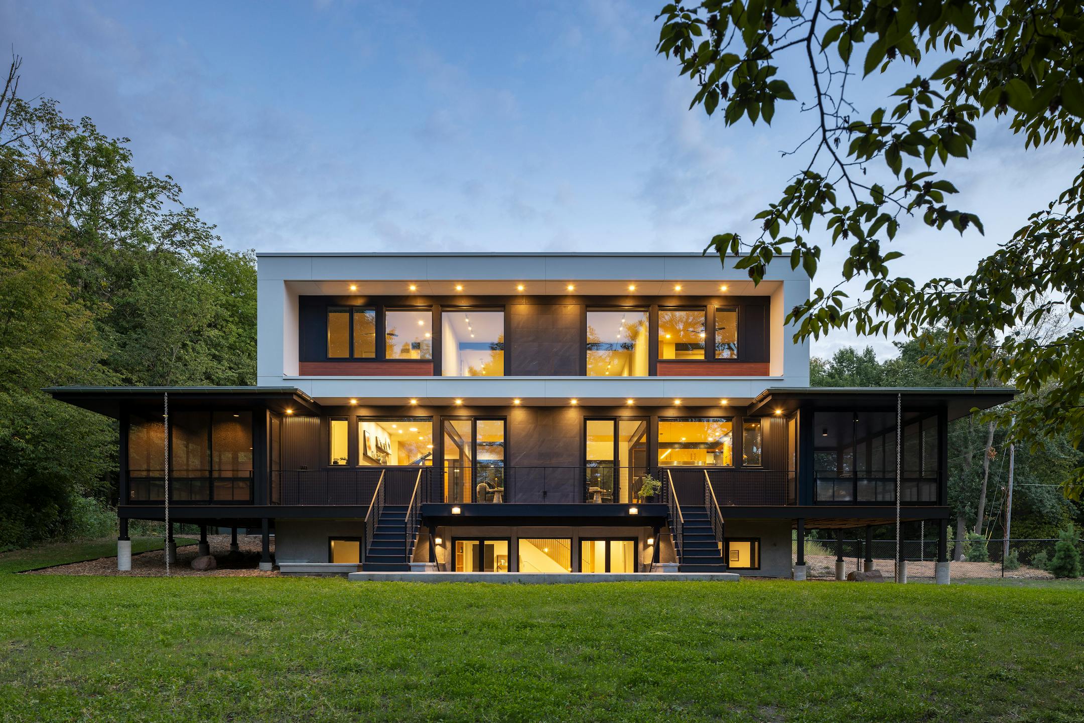 Nestled in the prairie on a gentle slope overlooking a pond, a site in Bloomington presented the perfect opportunity to build a net-zero home. The all-electric, highly insulated house with triple-pane windows, high-efficiency appliances, LED lighting, solar-paneled roof and geothermal heat pump system produces as much electricity as it consumes. Cedar accents and black corrugated metal help define the home’s elegance, as does a dream kitchen, two-story living and dining space as well as screened porches that maximize outdoor views.