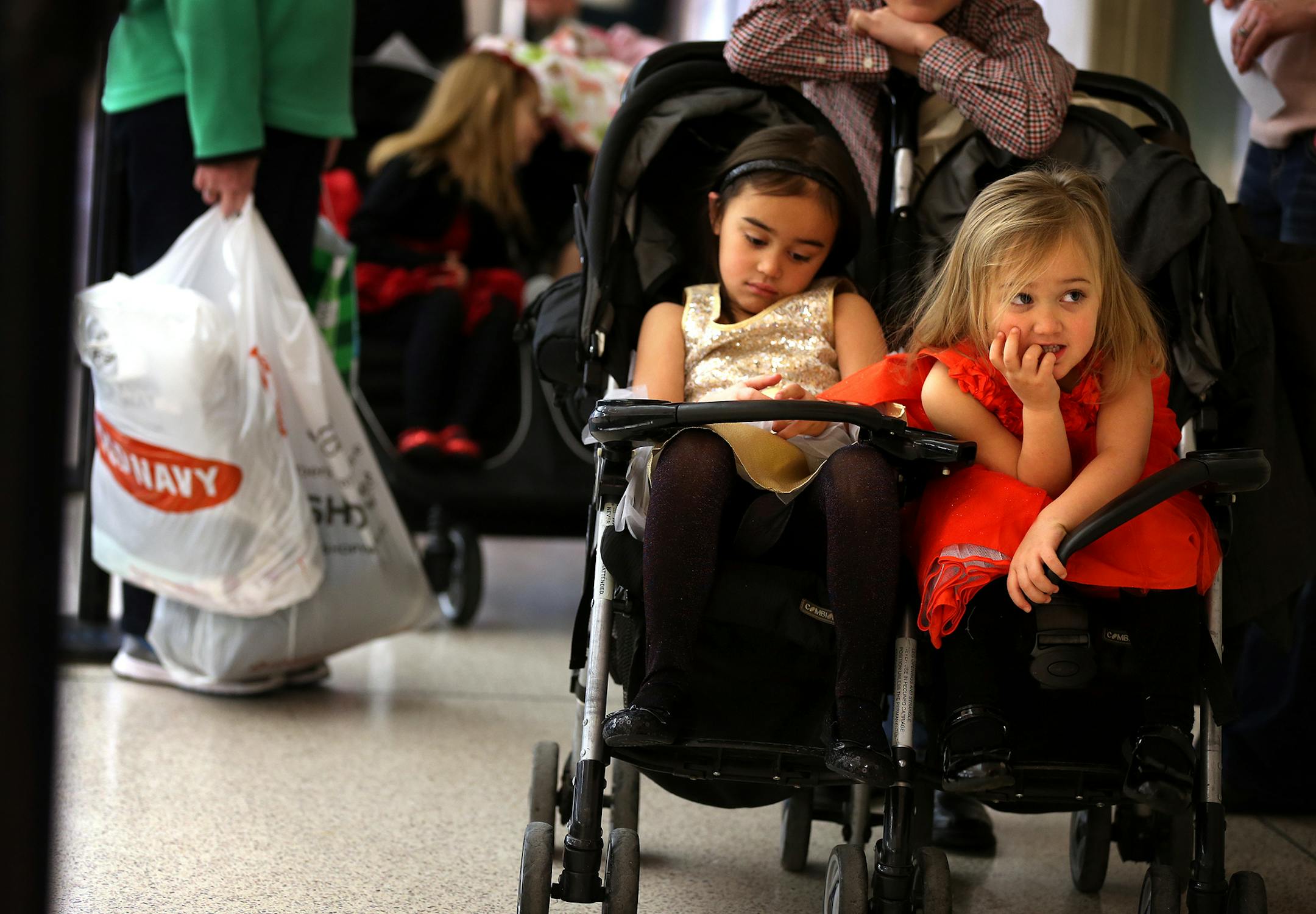 Sisters Kenley Nicolas, 5, left, and Kendyl Nicolas, 3, wait in line to visit Santa on Black Friday at Mall of America in Bloomington on Friday, November 28, 2014. ] LEILA NAVIDI leila.navidi@startribune.com /