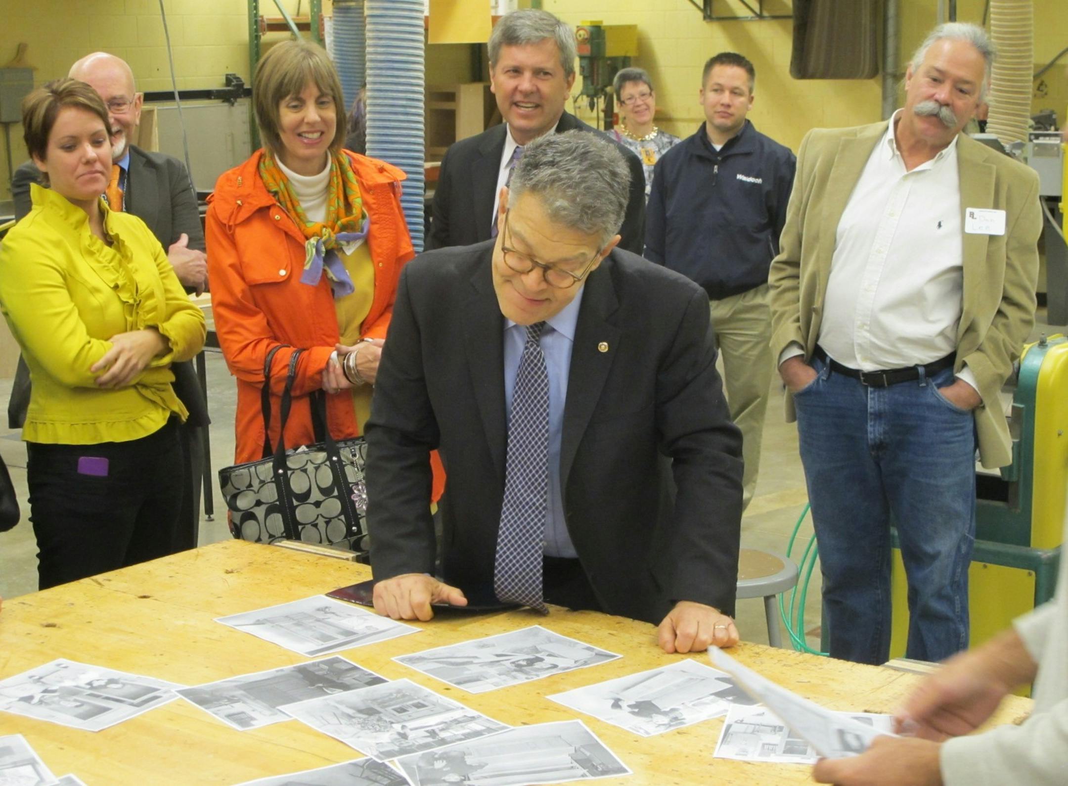 U.S. Sen. Al Franken on Tuesday studied student work from a woodworking class during his tour of Forest Lake High School.