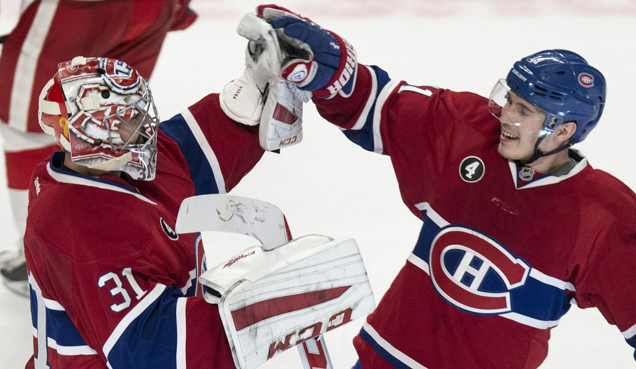 Montreal Canadiens goalie Carey Price is congratulated by teammate Brendan Gallagher following their 4-3 victory over the Detroit Red Wings during overtime in an NHL hockey game Thursday, April 9, 2015 in Montreal. Price broke a team record with 43 wins for a goaltender. (AP Photo/The Canadian Press, Paul Chiasson)
