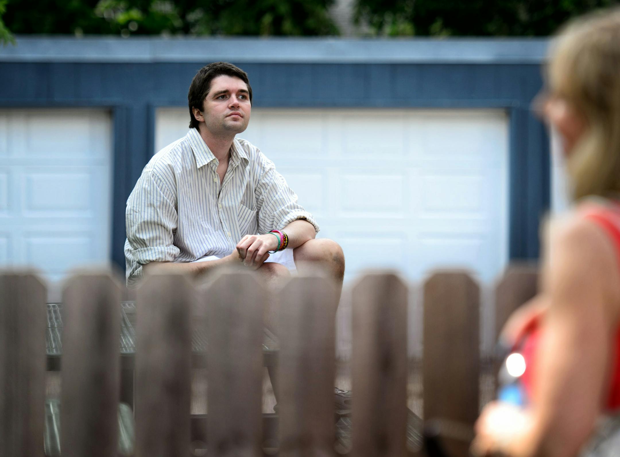 Ray Widstrand sat quietly on the picnic table outside his old apartment while his mom Linda waited on the other side of the fence.
