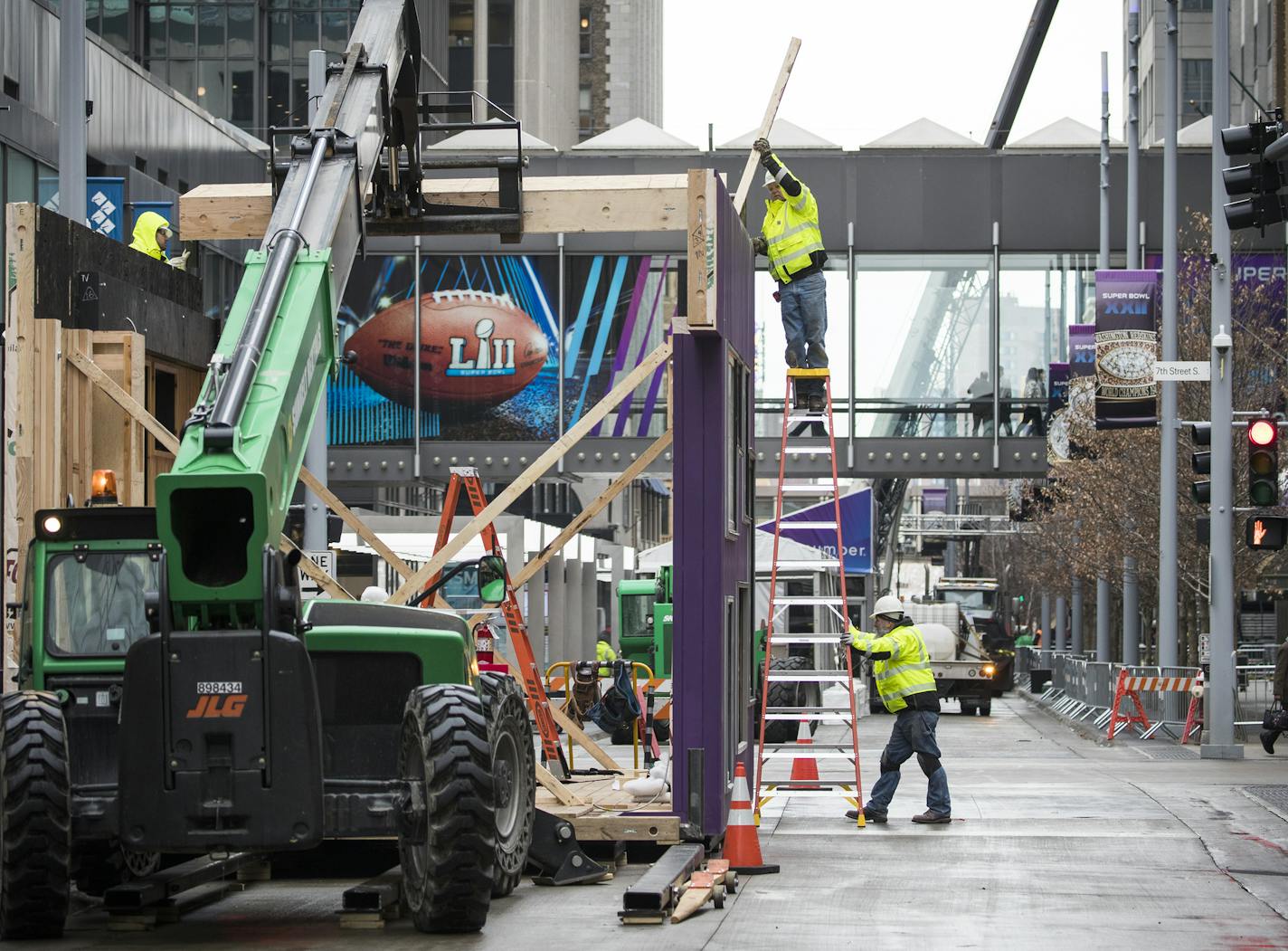 Jim Ayers, top, with Gardner Builders works on placing part of the roof on the Andersen Windows warming house. ] LEILA NAVIDI &#xef; leila.navidi@startribune.com BACKGROUND INFORMATION: Andersen Windows is building a combined warming house & KARE 11 broadcast studio on Nicollet Mall and 7th for Super Bowl Fans on Friday, January 19, 2018.