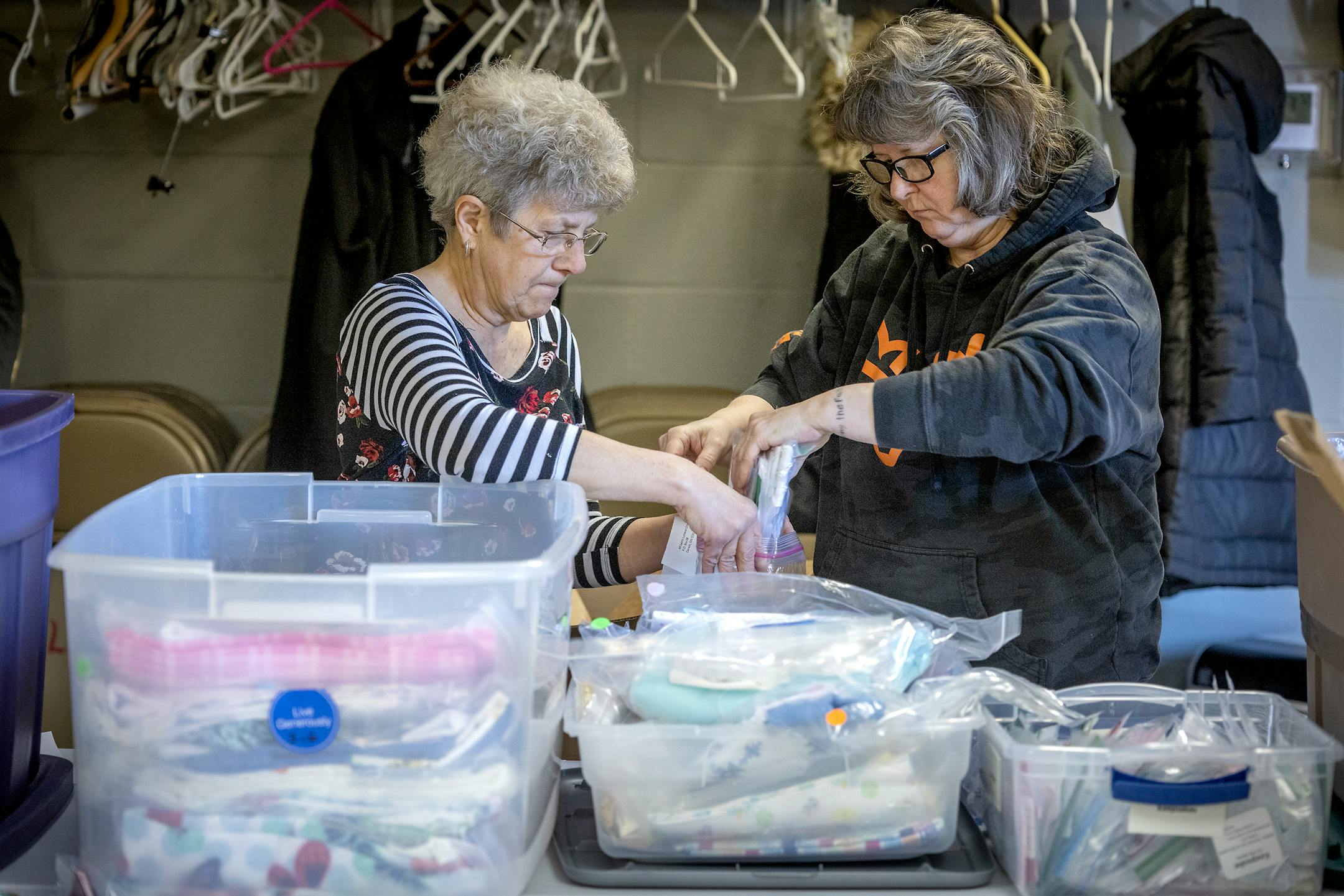 Lorraine Terlinden, cq, left, and Gayle Maurer, cq, package up "Angel Dresses" for delivery in the All Saints Lutheran Church basement in  Darwin, Minn.
