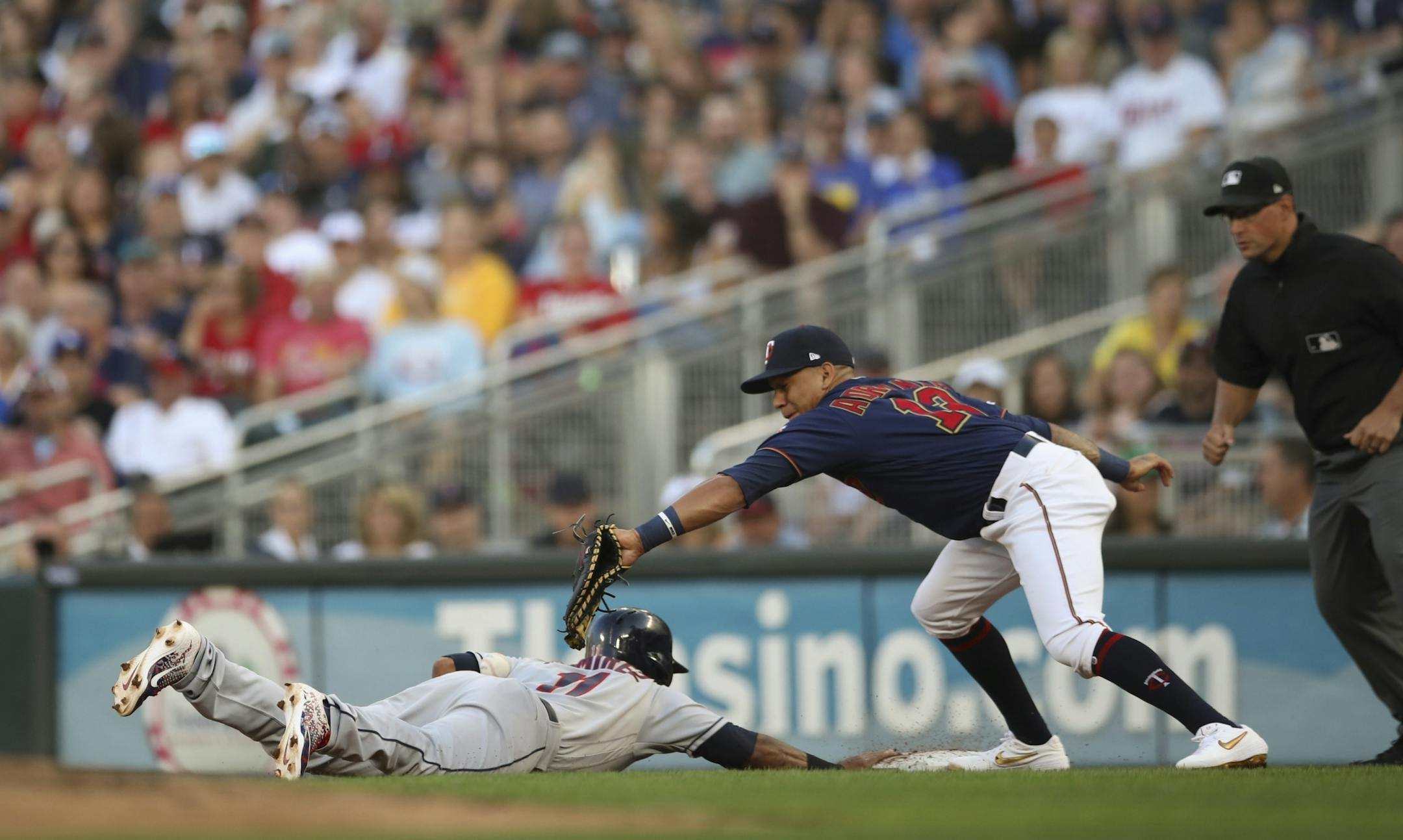 Minnesota Twins starting pitcher Kyle Gibson's throwing error on a pick off attempt on Cleveland Indians third baseman Jose Ramierez (11), out of the reach of Minnesota Twins first baseman Ehire Adrianza (13), allowed Cleveland's Yasiel Puig to score the first run for his team in the second inning.