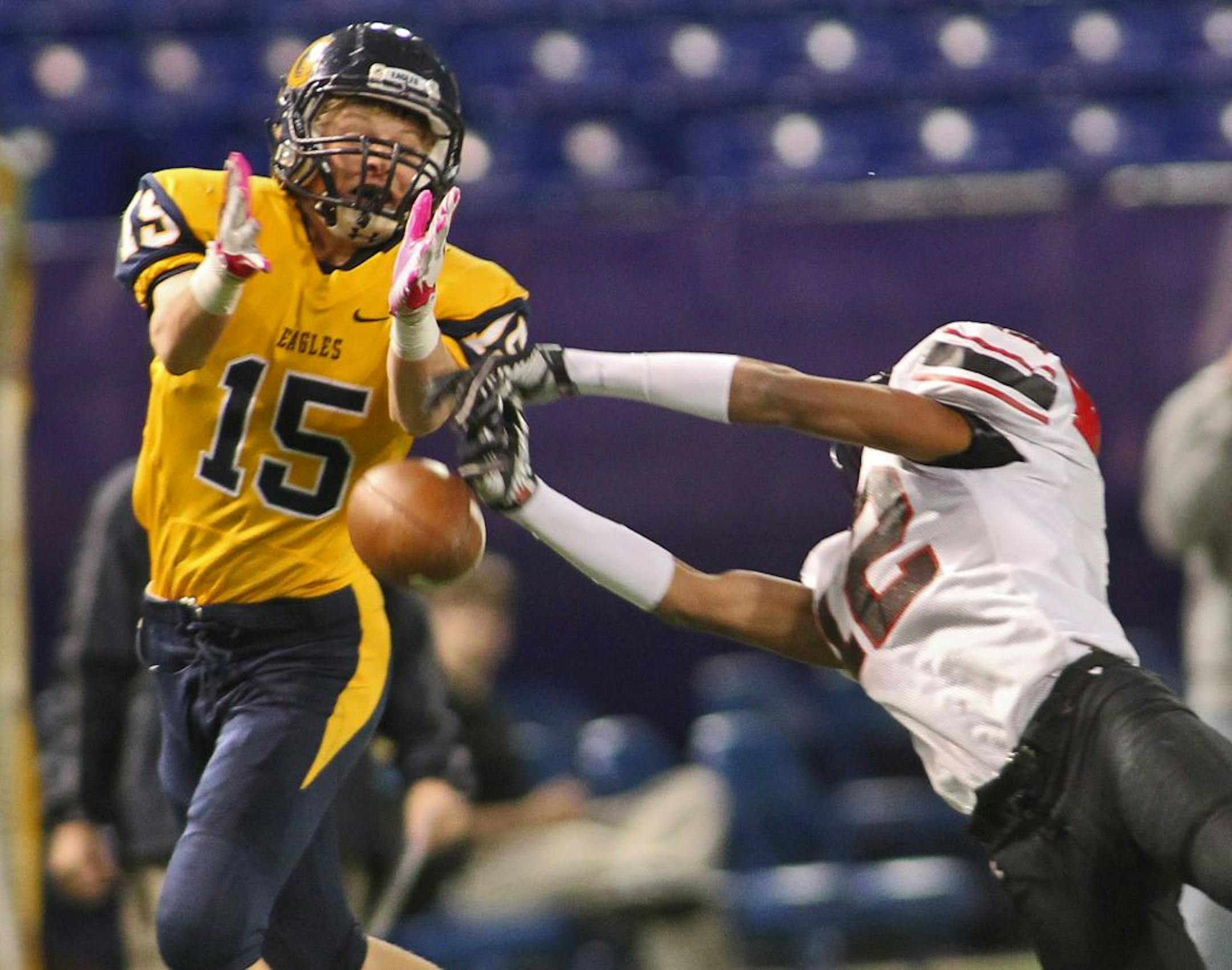 Totino-Grace had its hands full against Eden Prairie in the Nov. 18 semifinal game. Eden Prairie's Mozus Ikuennobe, right broke up a pass to Totino-Grace receiver Andrew McDonald (15).