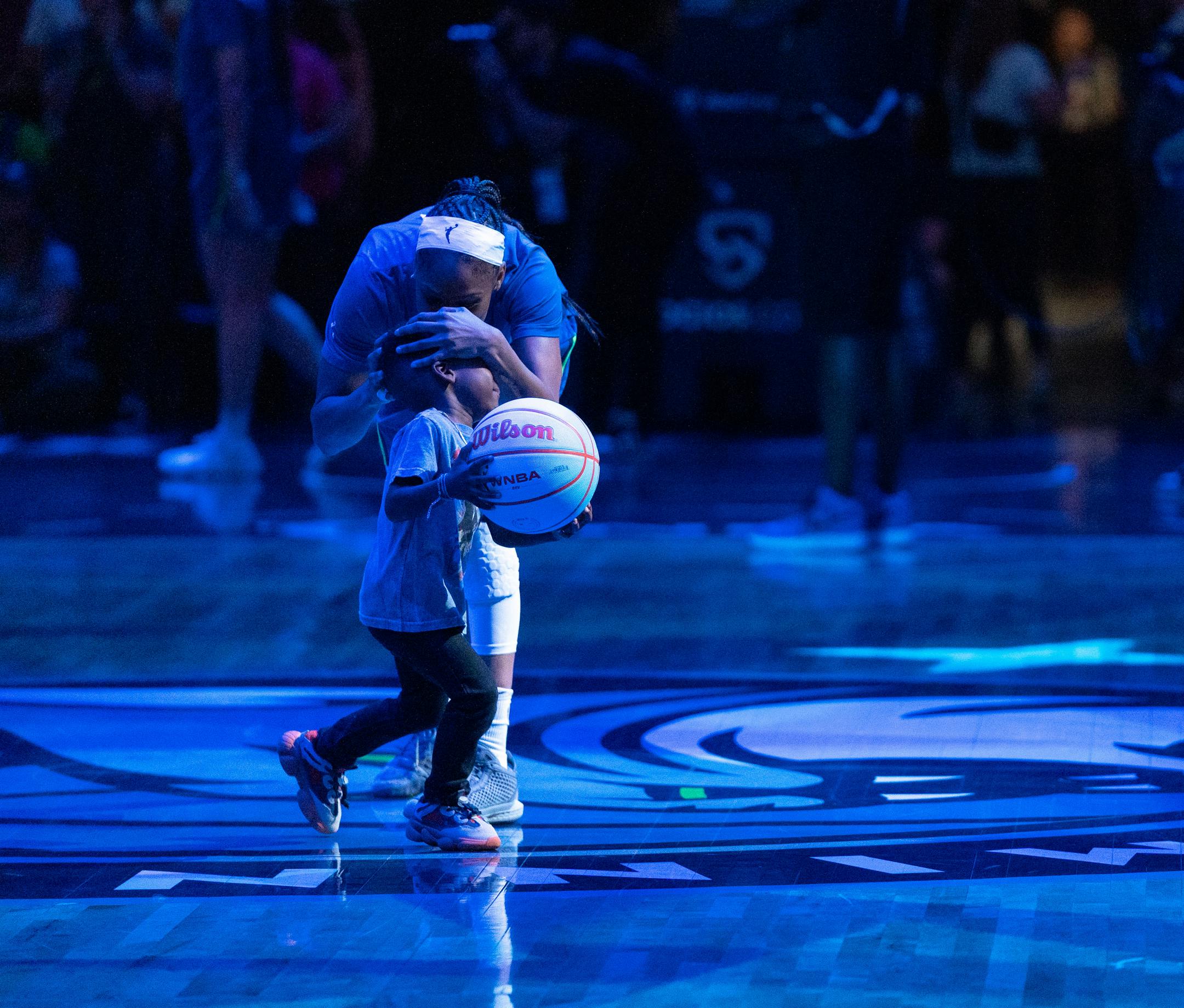 Minnesota Lynx guard Moriah Jefferson (4) gives a little boy an embrace before a game against the Las Vegas Aces.