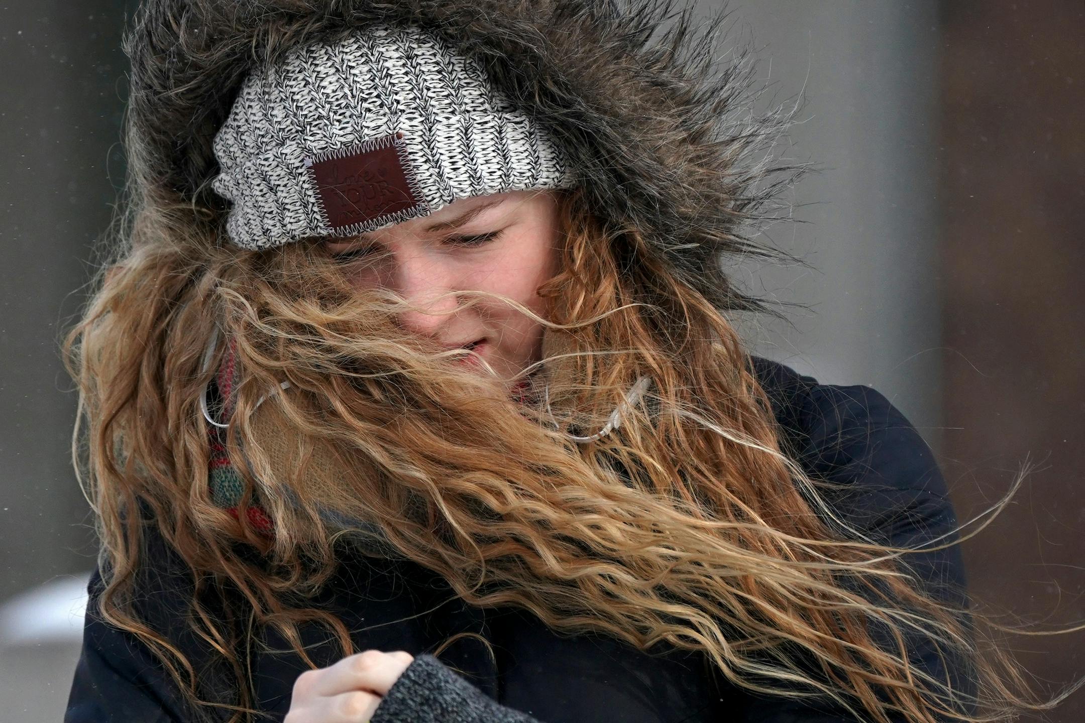 Katie Benedict, a freshman at the University of Minnesota studying biology, fought against the wind as she walked on campus Tuesday.