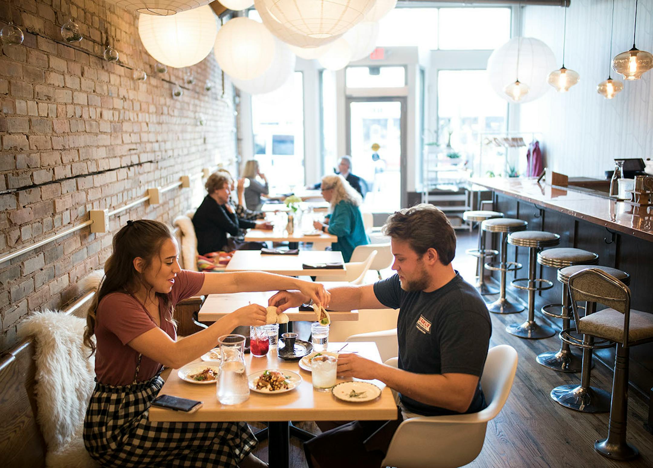 Heather Schultz and Ryan Ebhardt, both from Duluth, exchanged beef and chicken tacos during their date Wednesday night at Martha's Daughter.