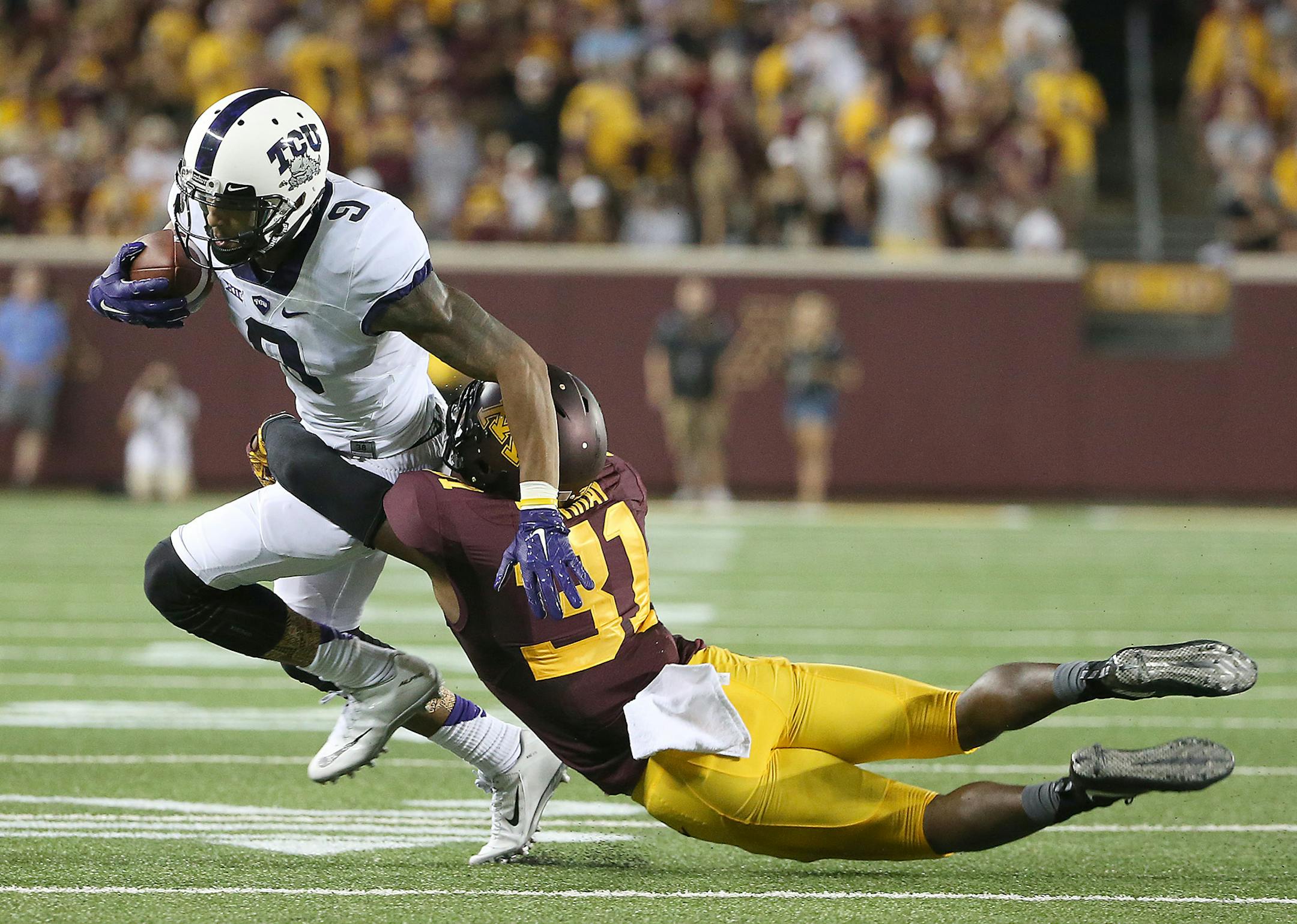 TCU wide receiver Josh Doctson was tackled by Gophers defensive back Eric Murray in a Sept. 2015 game at TCF Bank Stadium.