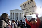 Lesa Curtis of Westchester, N.Y., right, who is pro agency fees and a former president of her union, rallies outside of the Supreme Court in Washingto