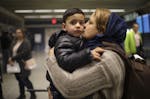 Marzeeya kissed her son, Abobakar, 3, as they got ready to leave MSP airport after their journey from Afghanistan.
