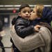 Marzeeya kissed her son, Abobakar, 3, as they got ready to leave MSP airport after their journey from Afghanistan.