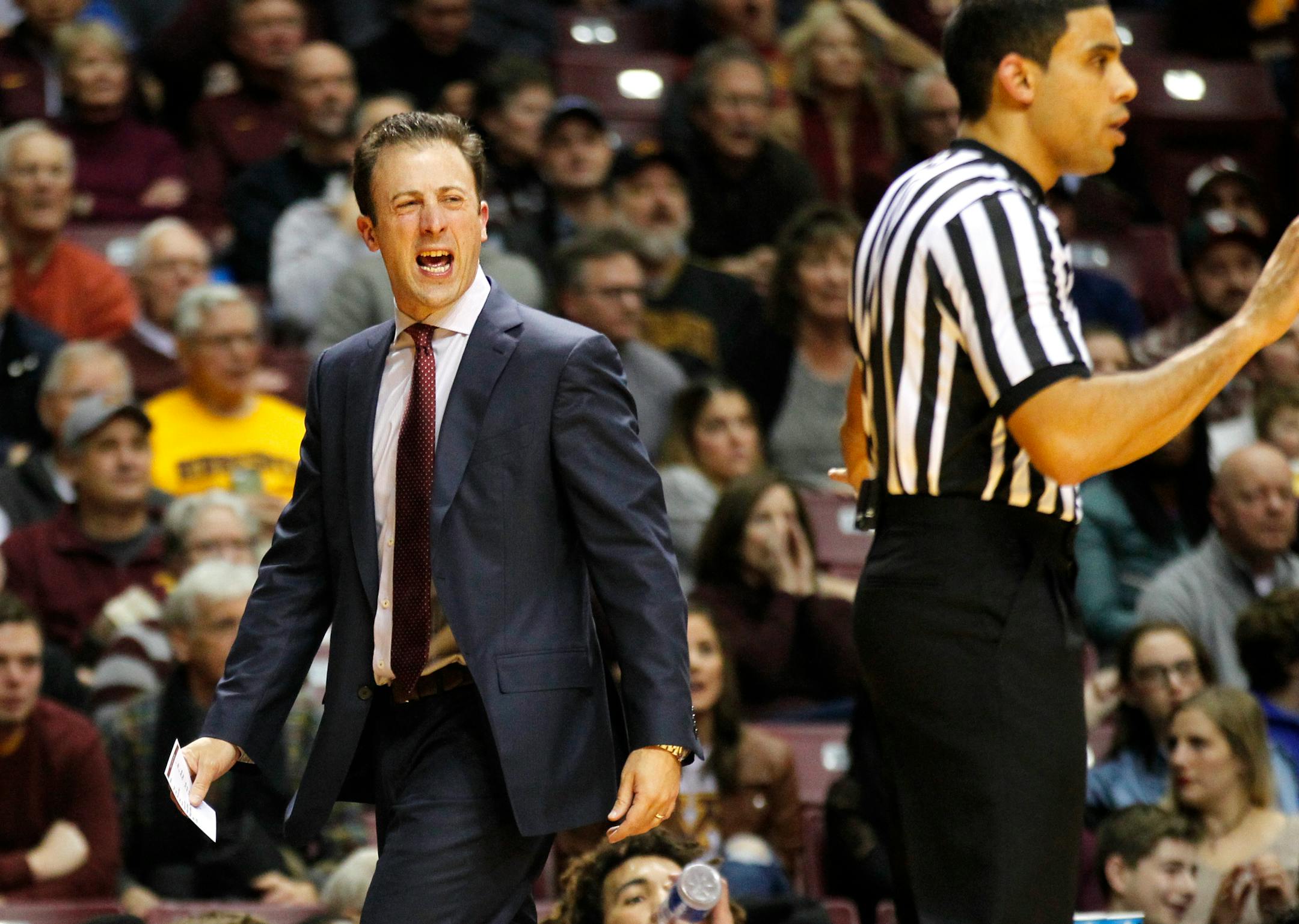 Minnesota head coach Richard Pitino, left, argues about a call against Arkansas State in the second half of an NCAA college basketball game Friday, Dec. 23, 2016, in Minneapolis. (AP Photo/Andy Clayton-King)