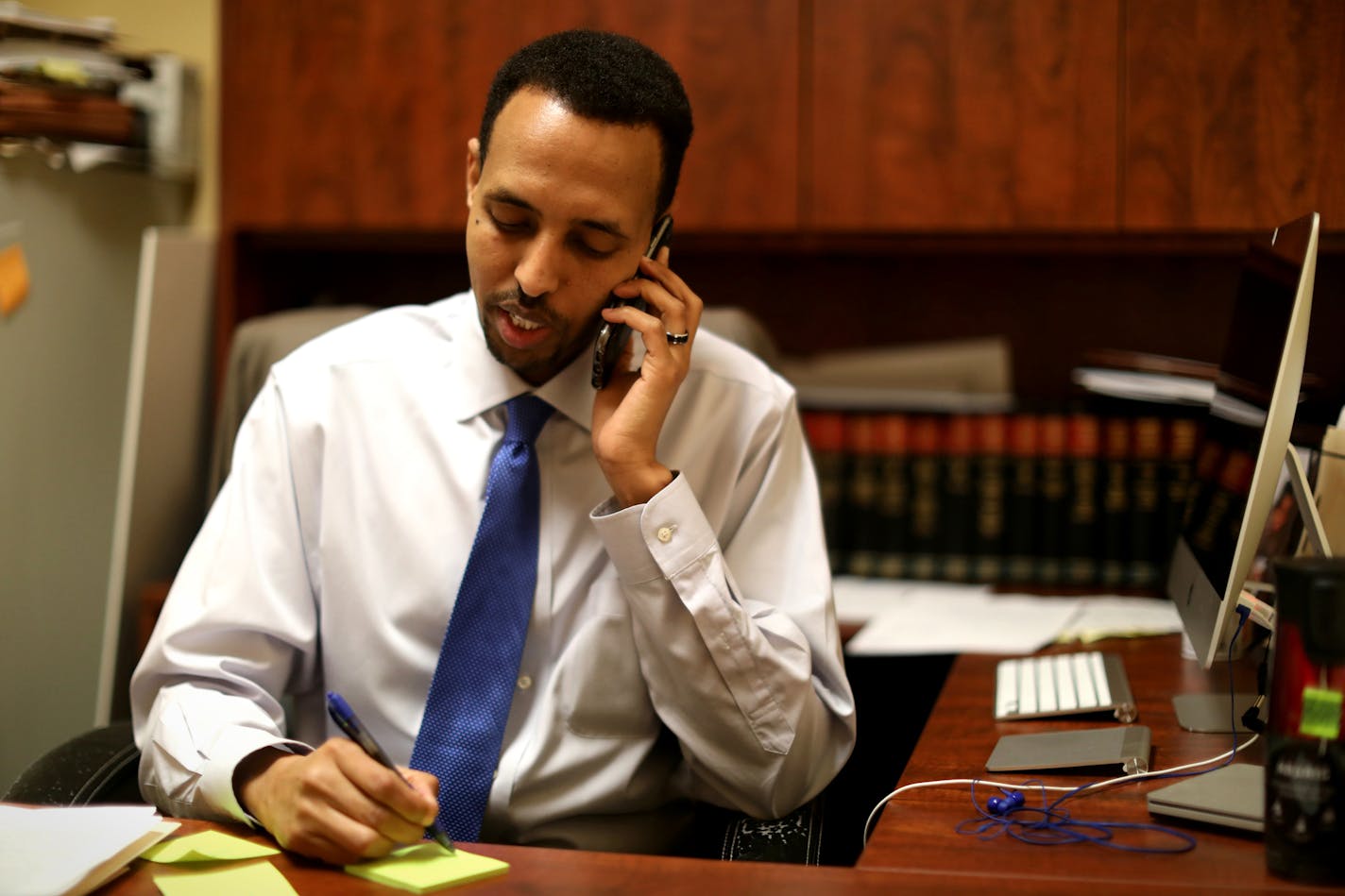 Immigration attorney Abdinasir Abdulahi said he took calls all morning from concerned people in the commuity in response to rumors of Pres. Donald Trump's announcement on his immediate plans for immigration. Photographed in Minneapolis, Minn., on Wednesday, January 25, 2017. ] RENEE JONES SCHNEIDER * reneejones@startribune.com note in this photograph he is NOT taking a call from a client.