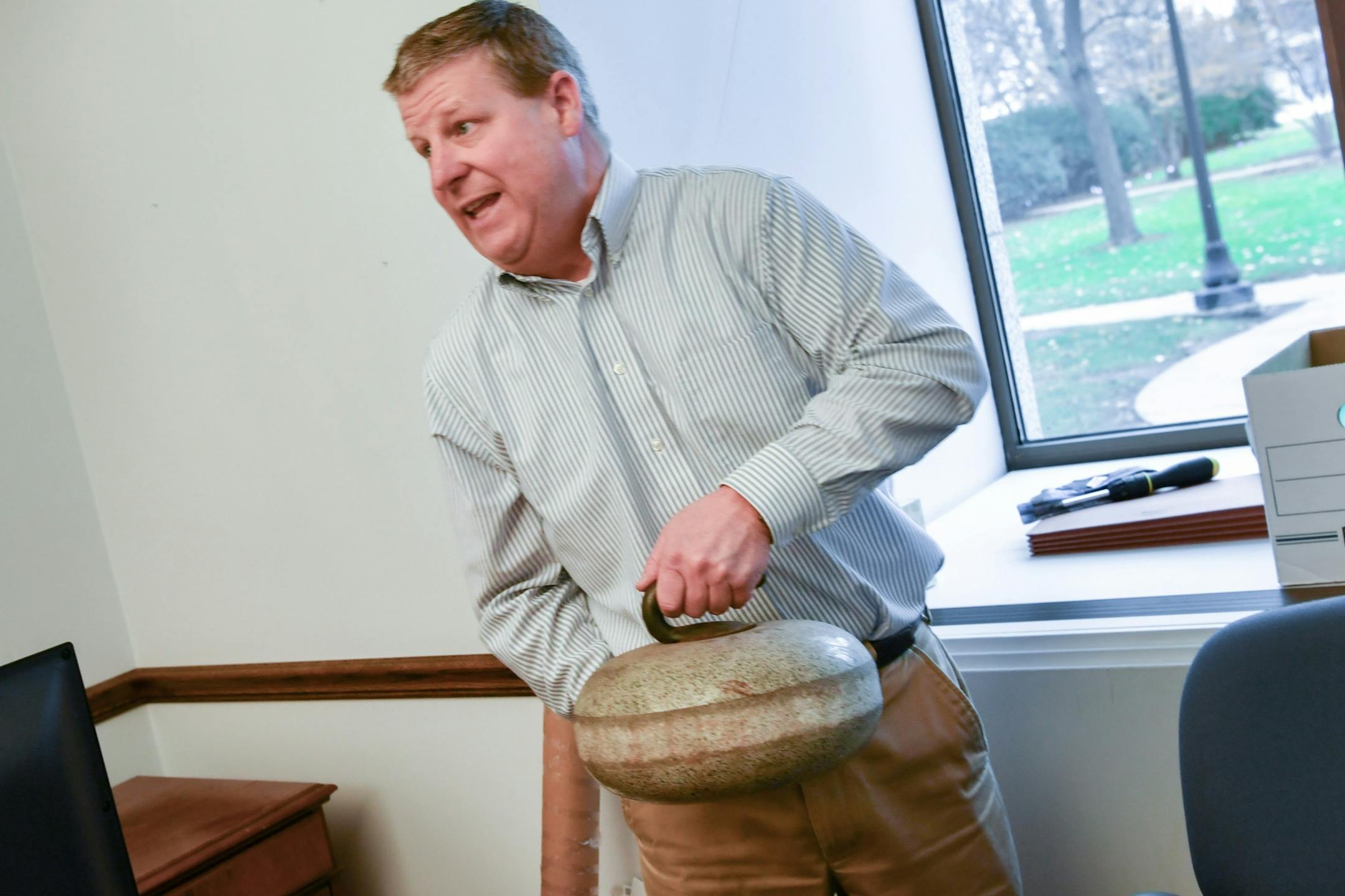 Bill Walsh, Republican policy development director decided to take this 40-pound curling stone home rather than moving it to his new office. It was a gift from former Senator David Hann.